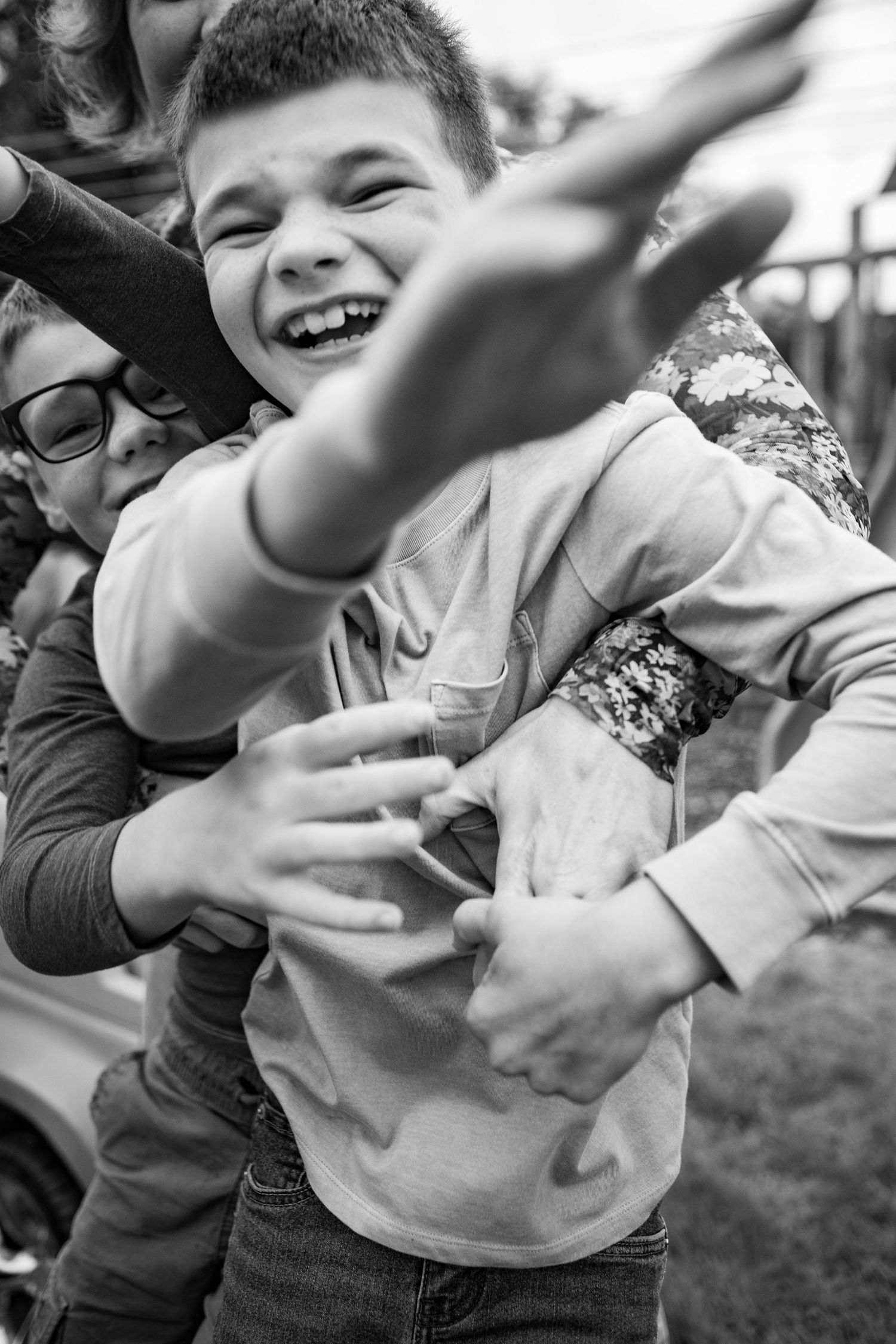 Black and white sequence of joyful outdoor playtime with movement and laughter.