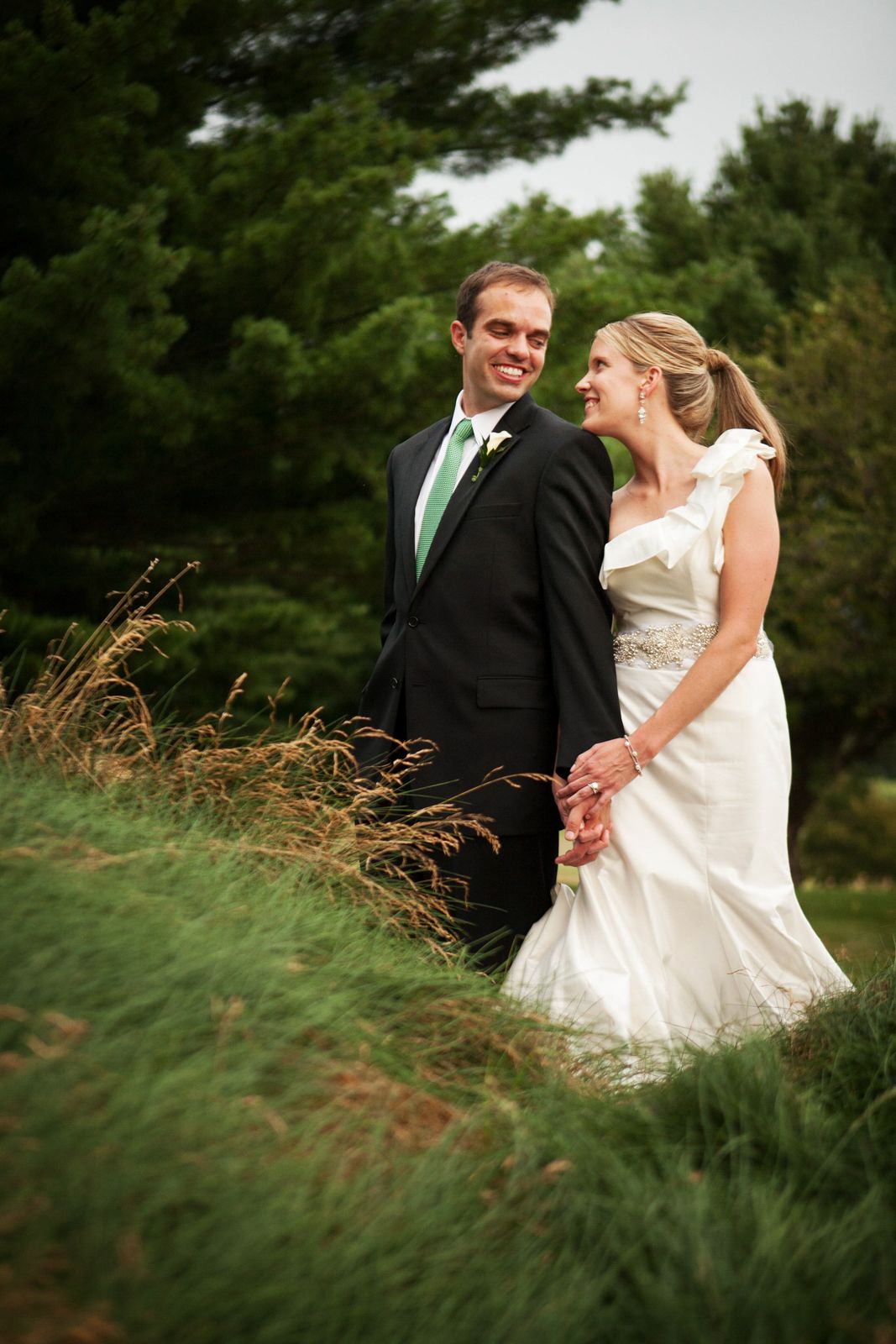 couple smiling by tall grass