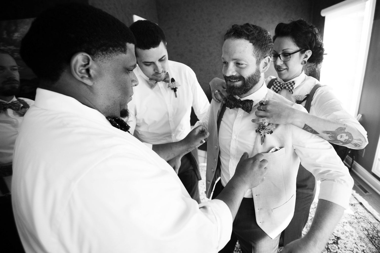 groom being dressed and fussed over