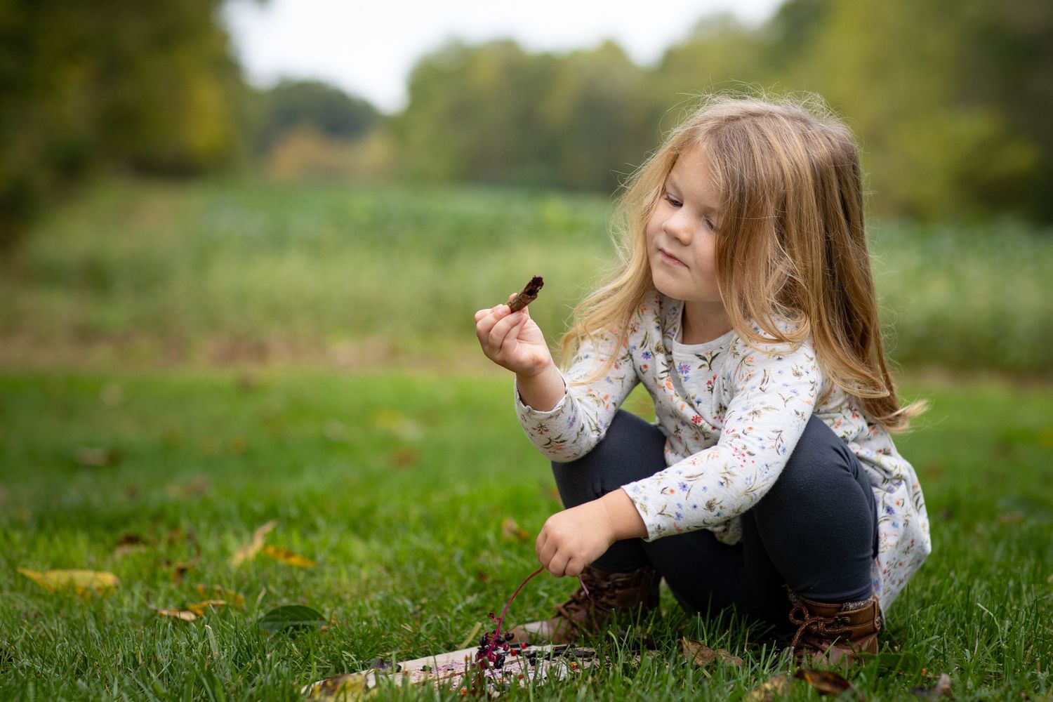 Person lying in grass during an autumn day outdoors.