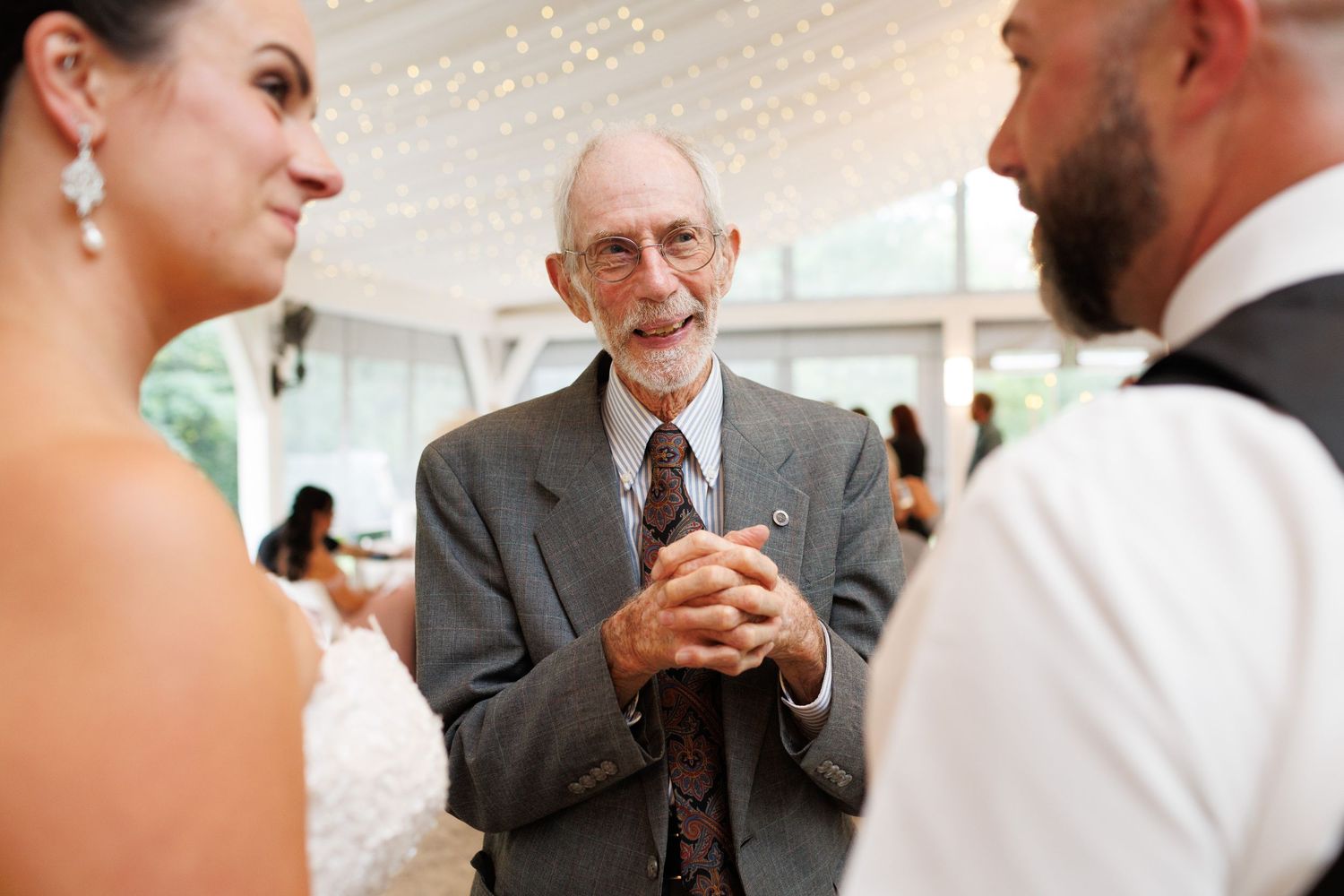 Candid reception moments showing guests in formal attire interacting and laughing.