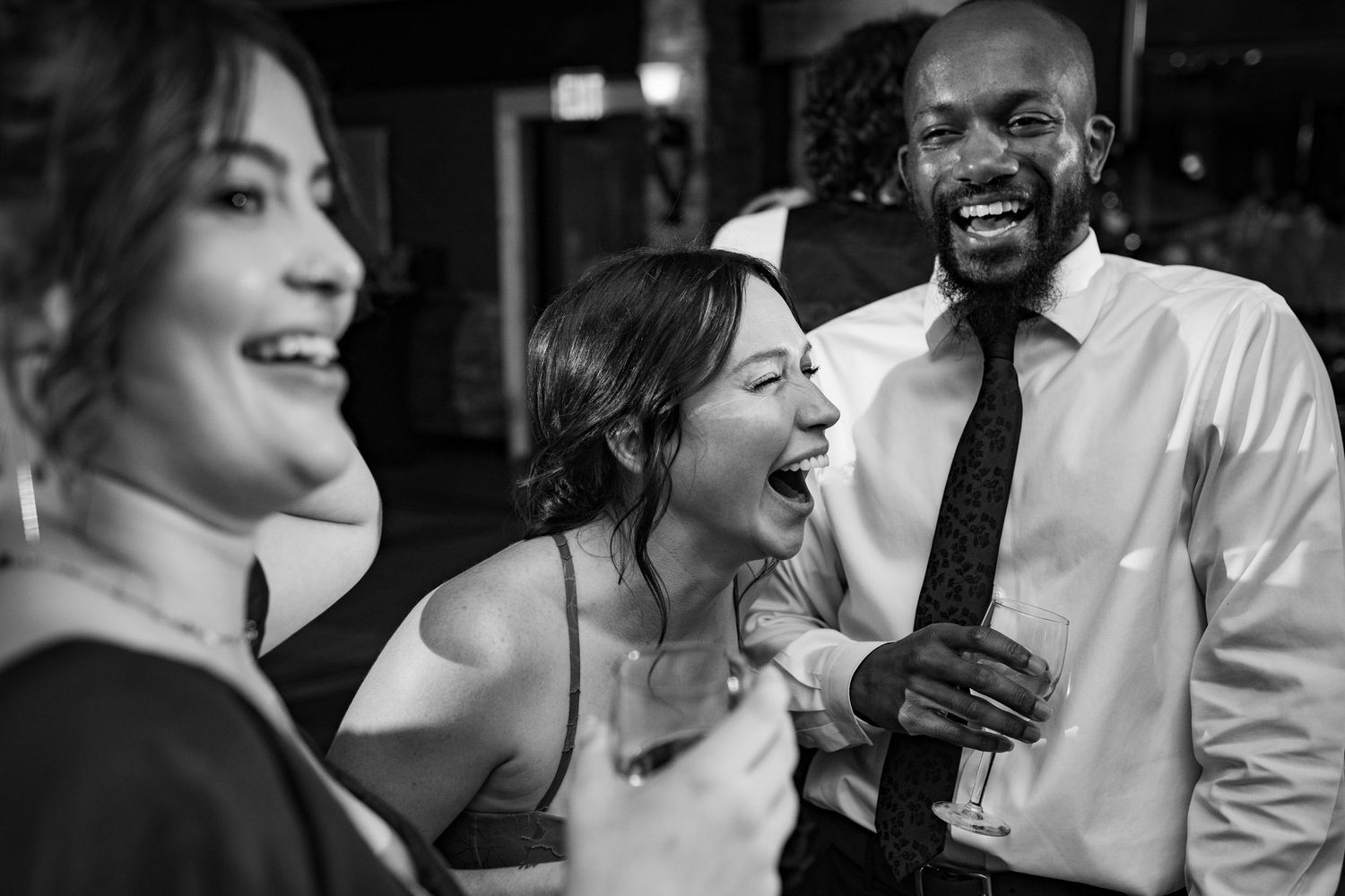 Guests laugh and celebrate together on the dance floor at a wedding reception.
