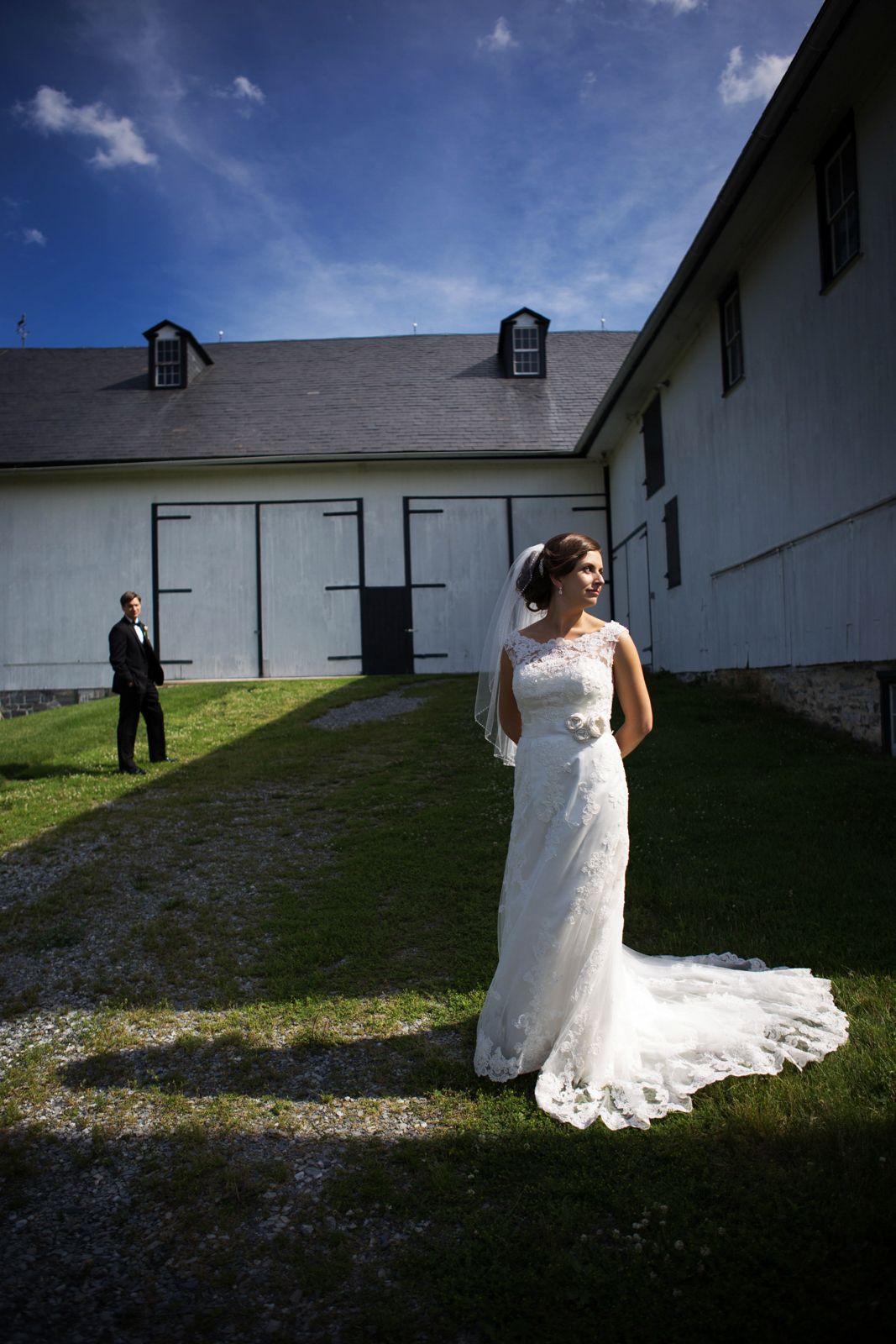 bride and groom by a barn