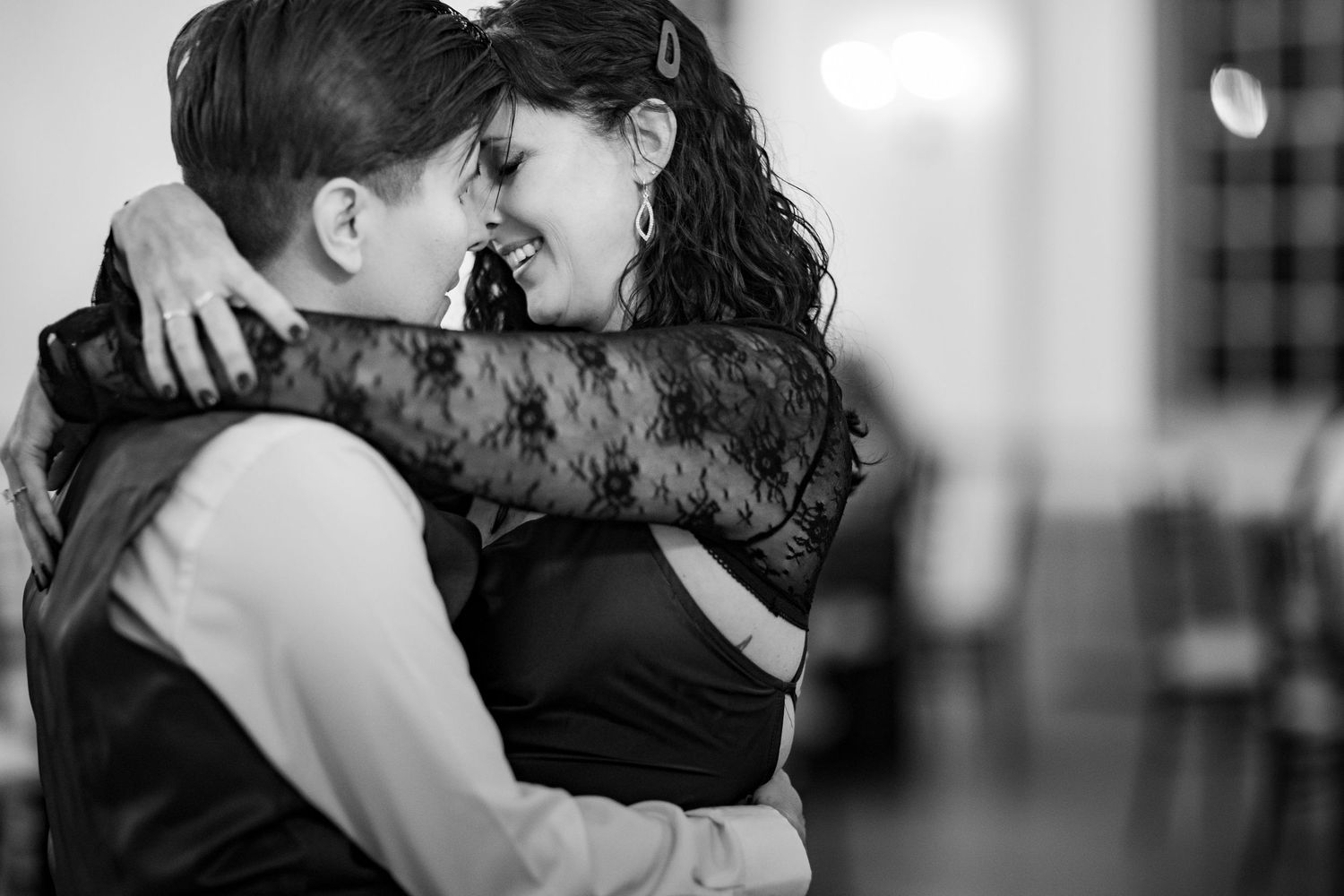 Intimate black and white photos of couples sharing romantic moments on the dance floor.