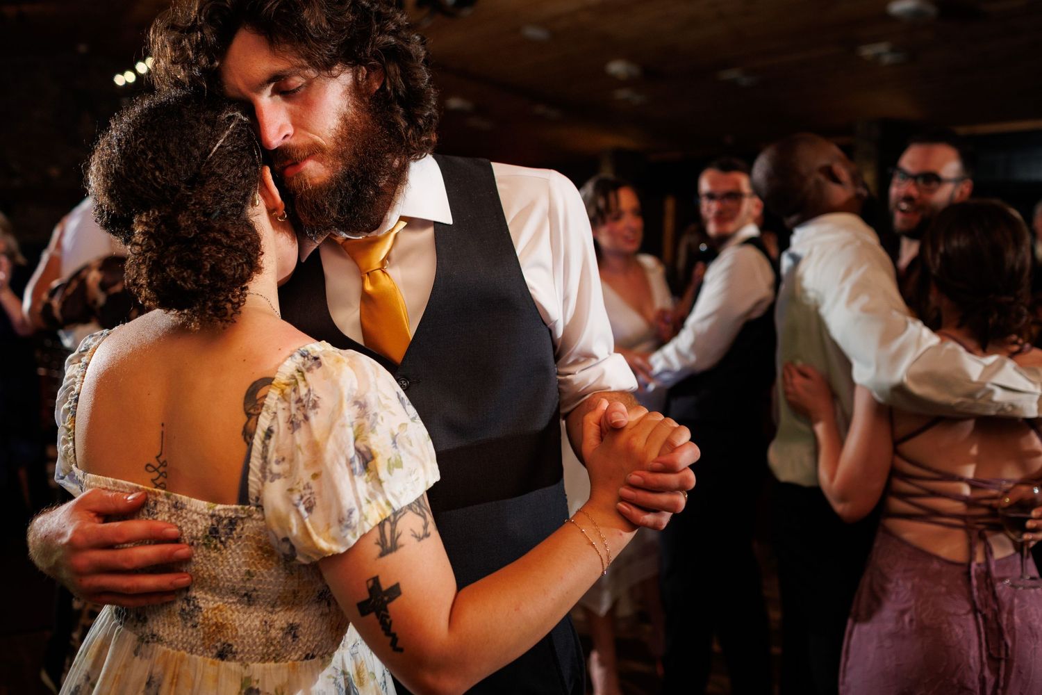 Couple shares an intimate slow dance embrace at a romantic wedding reception.