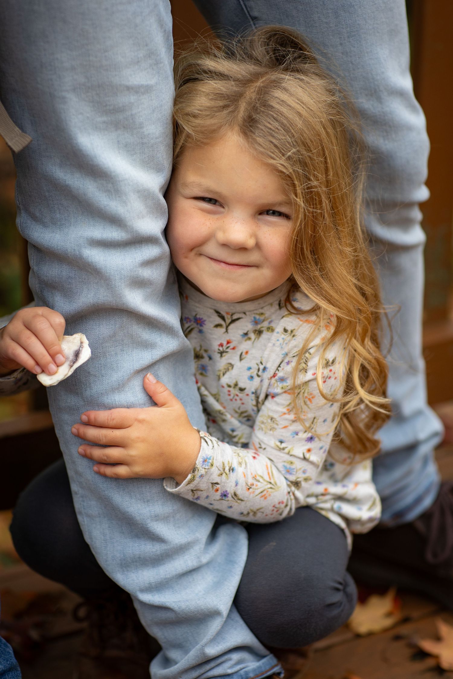 Close-up sequence showing someone hugging a person wearing a gray sweatshirt.