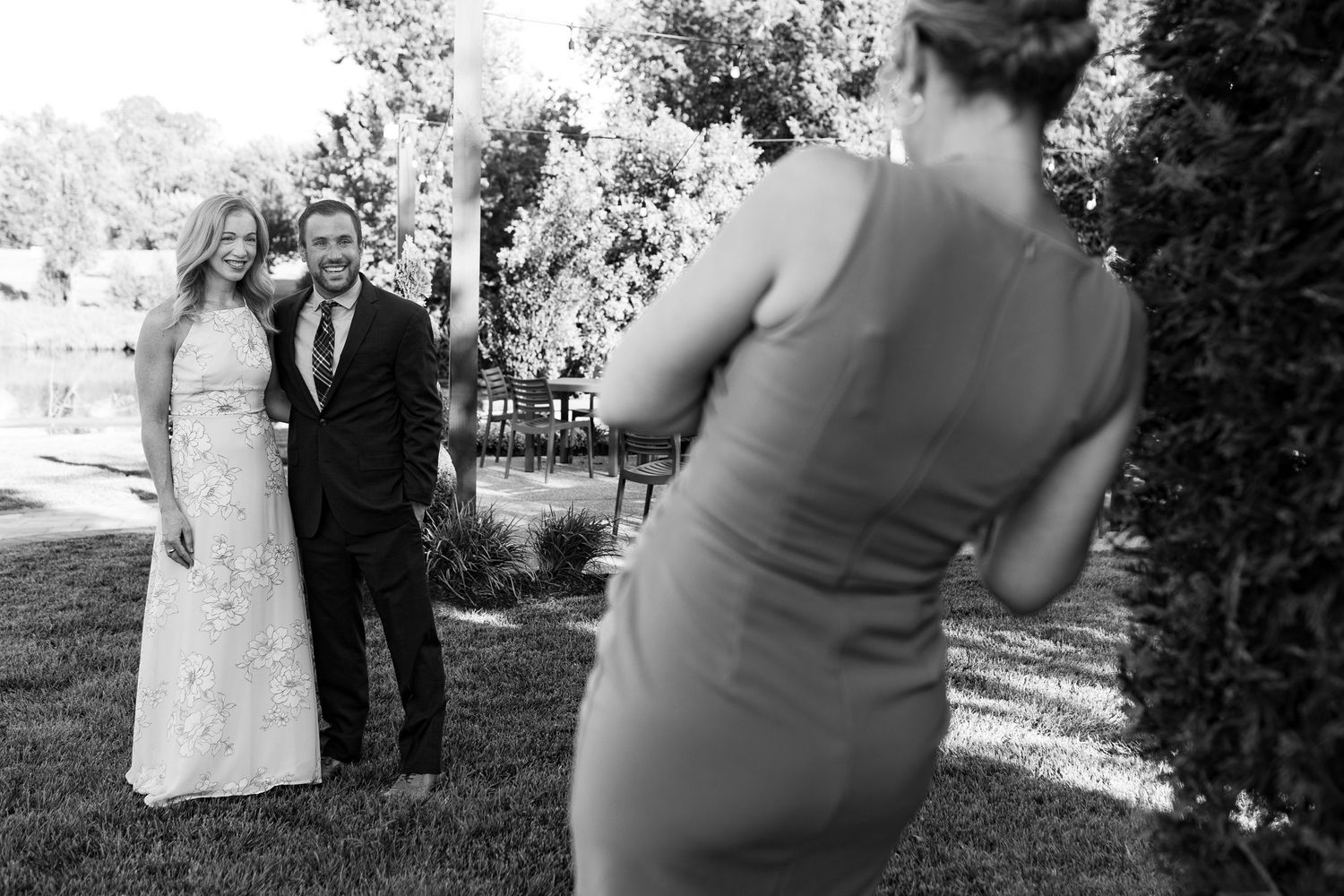 A lively outdoor wedding reception scene with dancing couples and guests enjoying themselves on the dance floor.