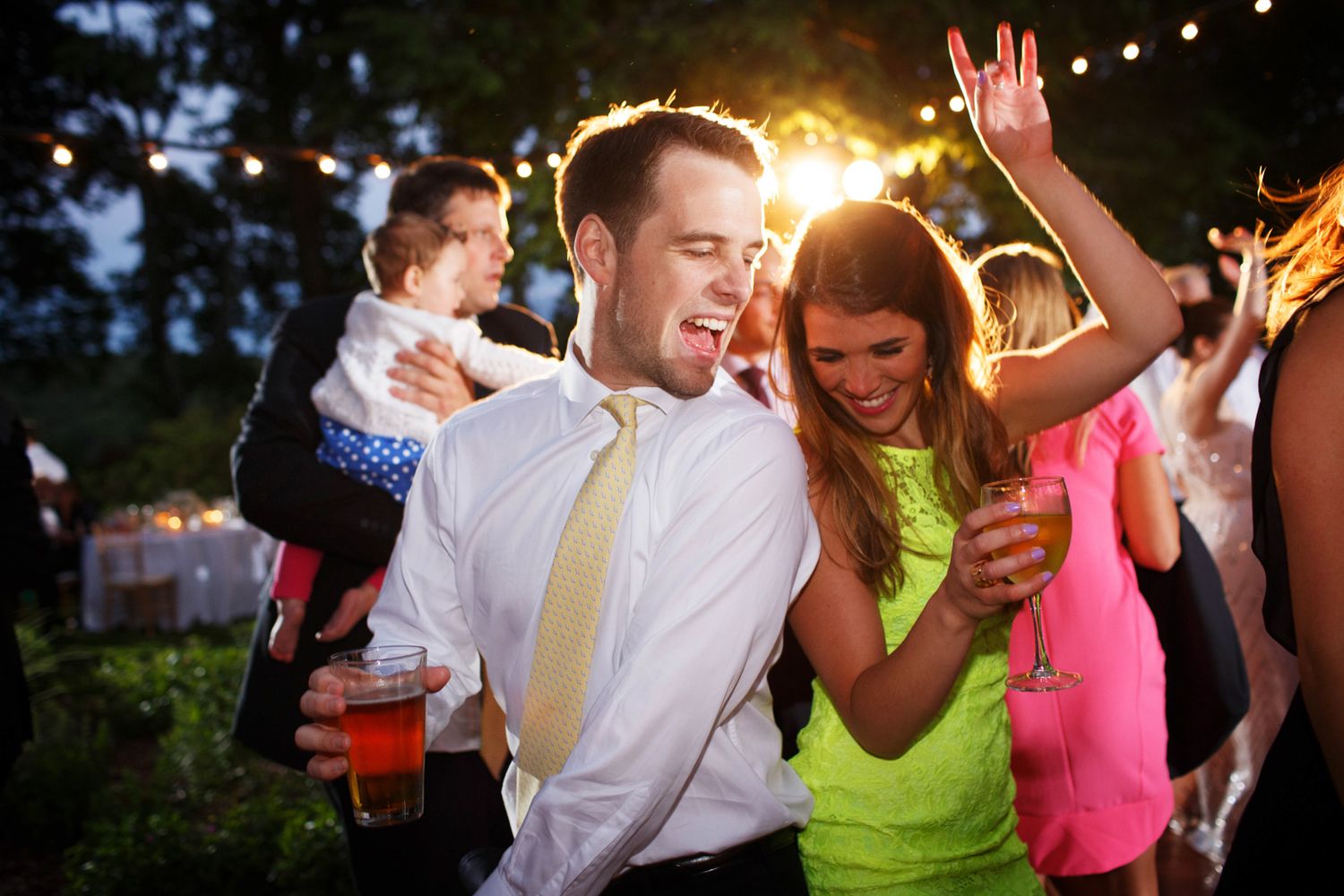 a man and a woman dance and have a great time at a wedding reception