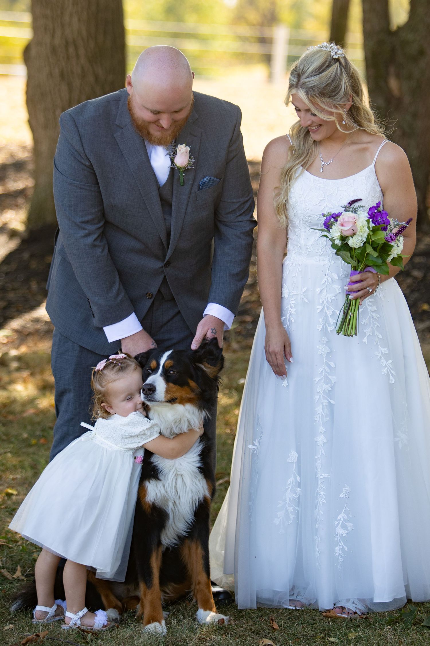 Four consecutive wedding photos show a bride in a white dress and a small flower girl petting a dog during an outdoor ceremony.