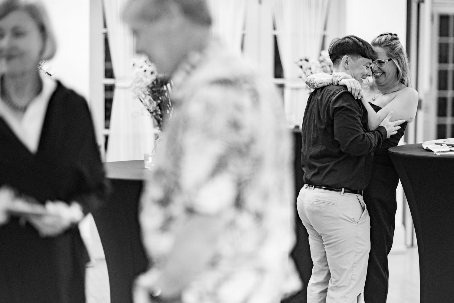 A series of black and white wedding photos showing couples dancing and celebrating at a reception.