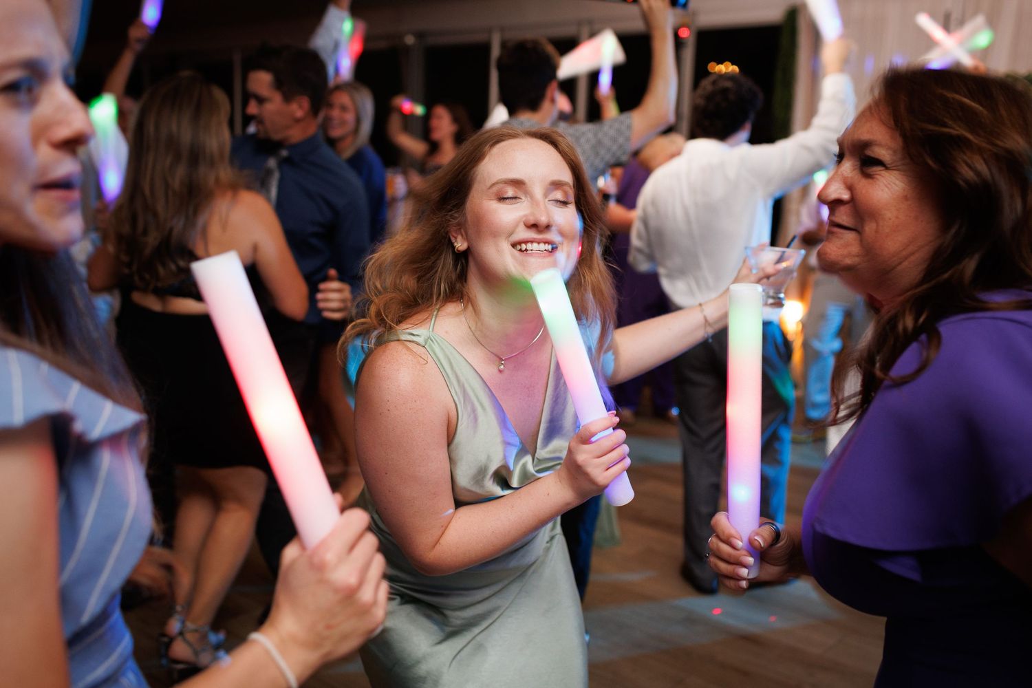 People dancing and celebrating together at a lively indoor party or social gathering.