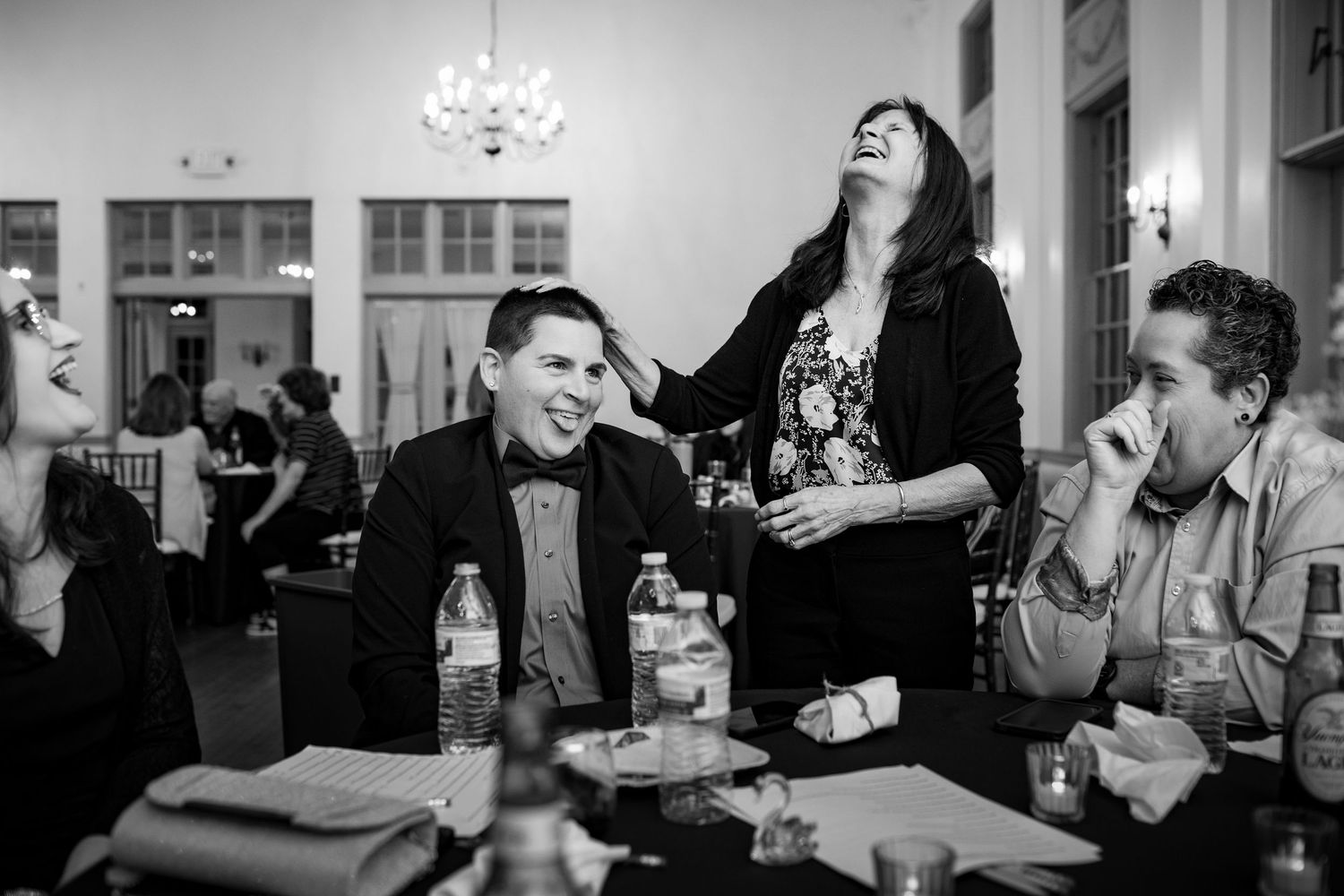 Black and white photos of people enjoying conversation and drinks at a social gathering.