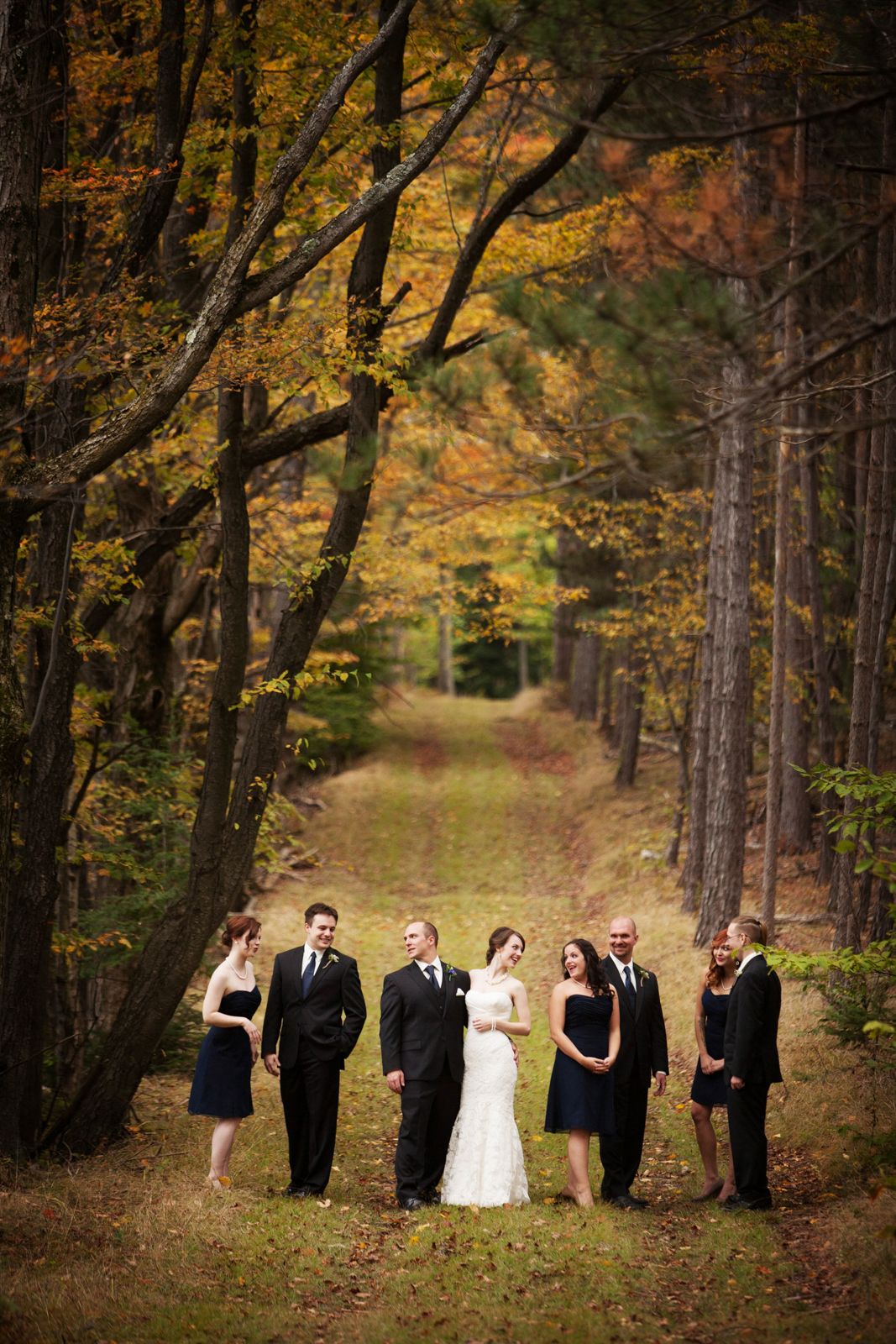 country lane wedding party photo in Fall leaves