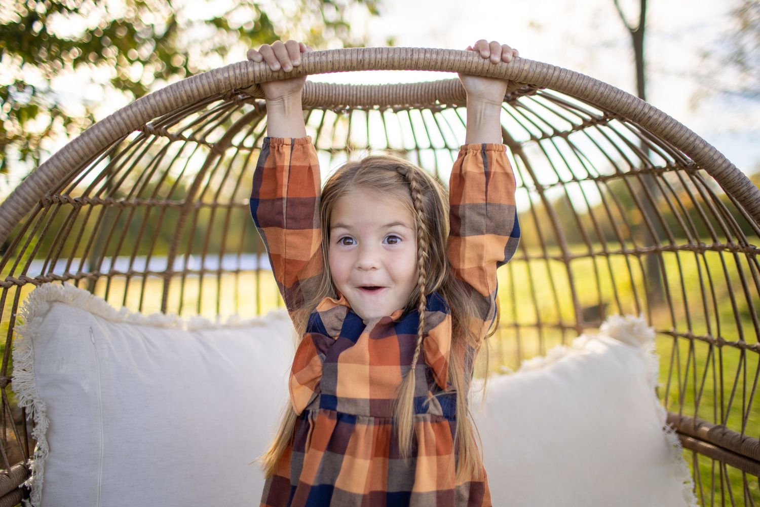 A hanging rattan egg chair sequence showing joyful expressions and movement in an outdoor setting.