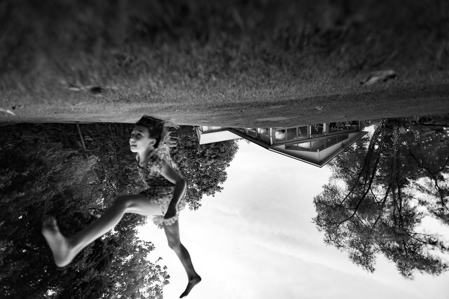 A creative black and white upside down reflection of a wedding couple in artistic composition.