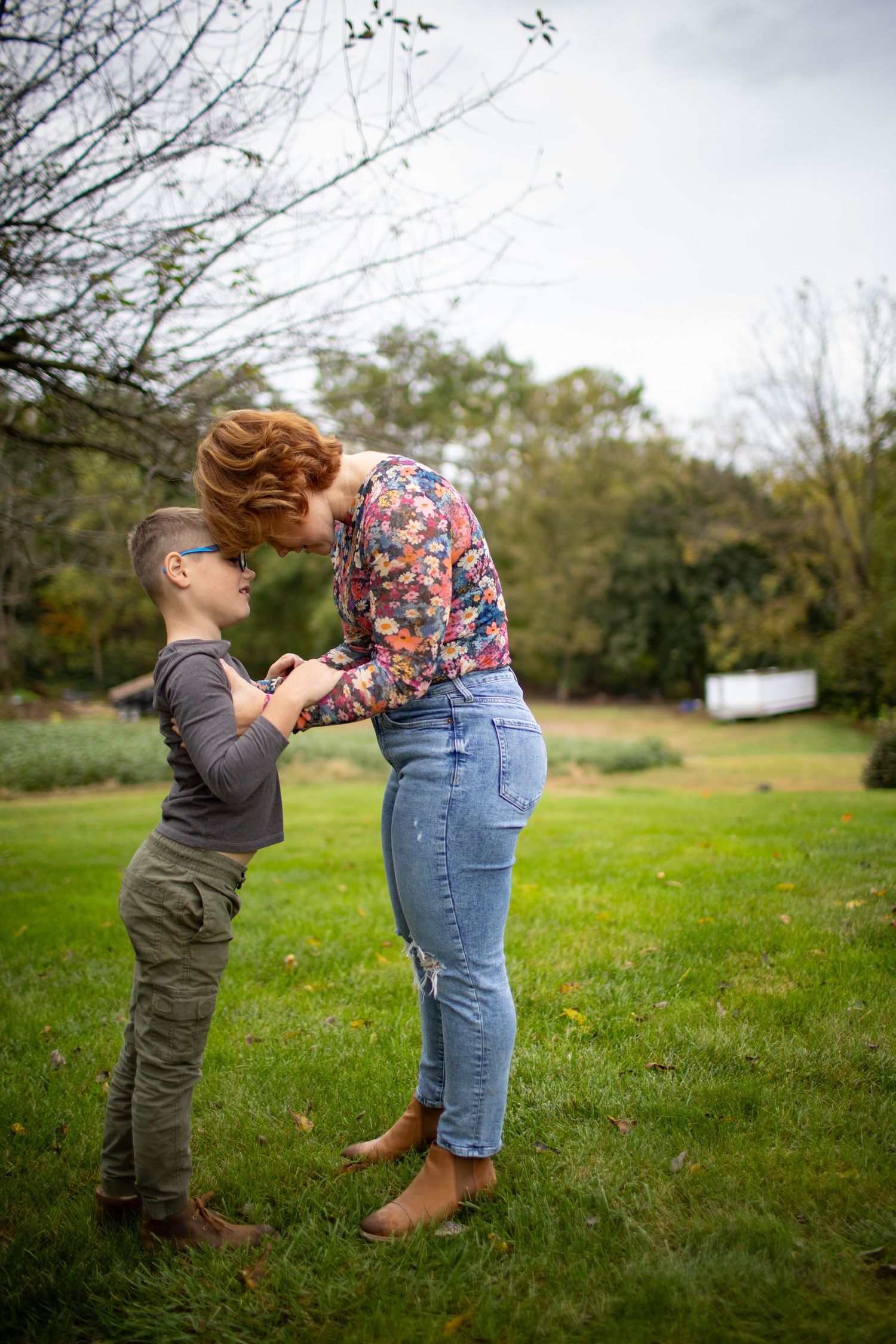Playful sequence of two people in casual clothes interacting on a grassy field.