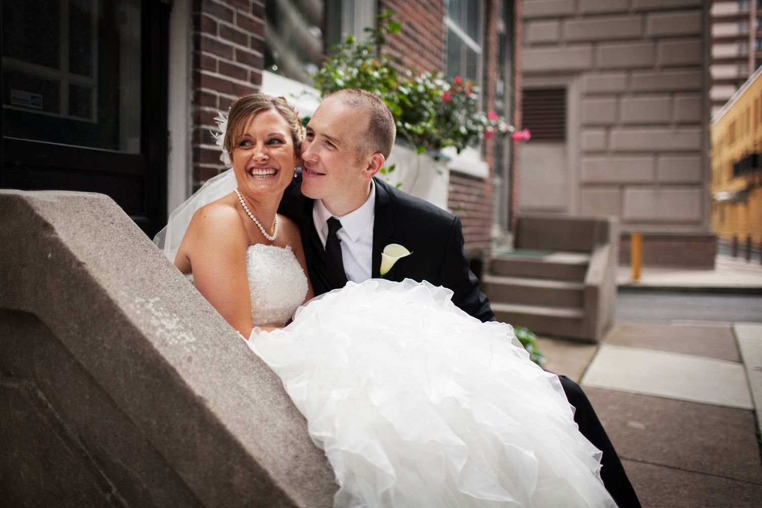 A couple smiling on a step just after their wedding in Lancaster, PA