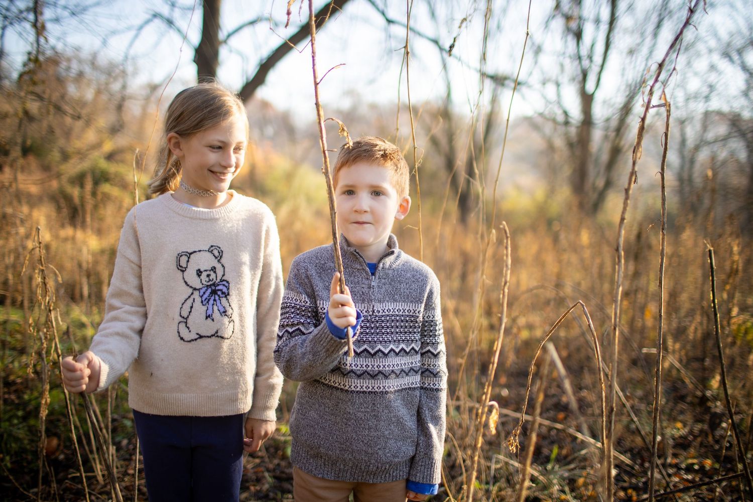A series of outdoor family portraits taken in a natural setting with bare trees and golden sunlight.