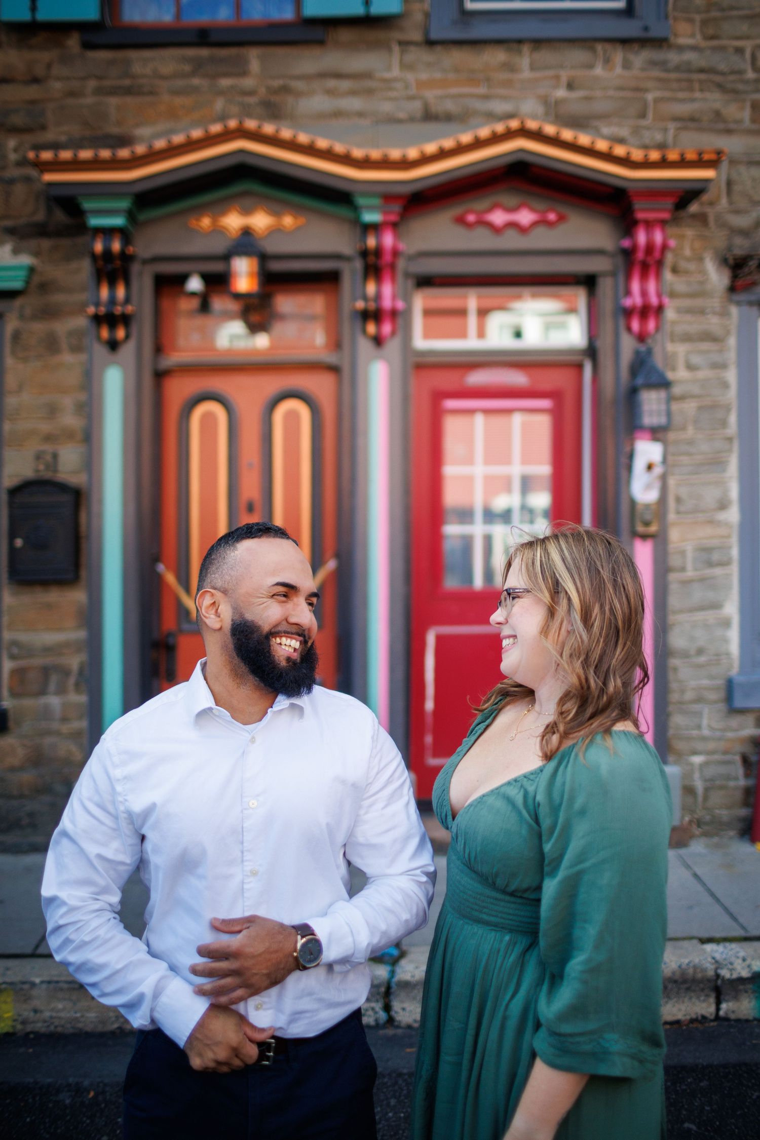 A playful series of interactions captured outside a vintage-style building with decorative lighting and stone walls.