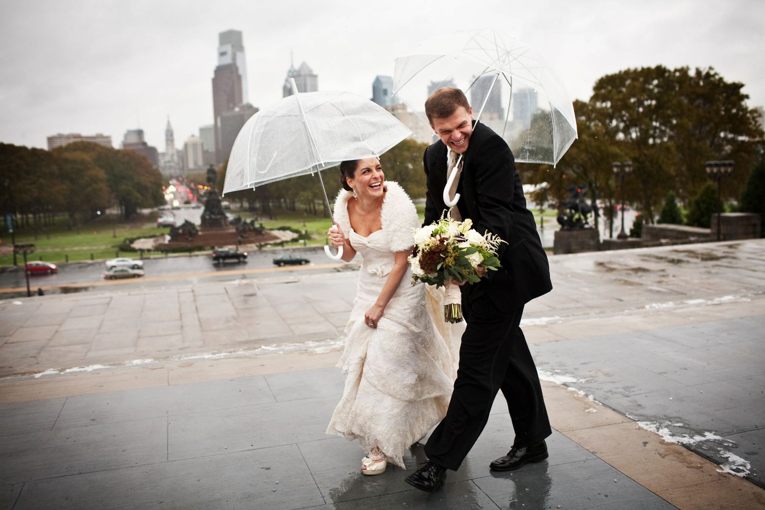bride and groom in Philadelphia in the rain on the steps of the Philadelphia Museum of Art