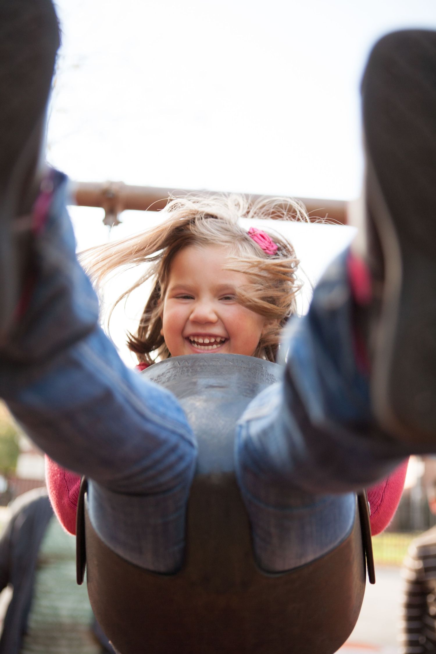 Playful upside down portrait with joyful expressions and windswept hair.