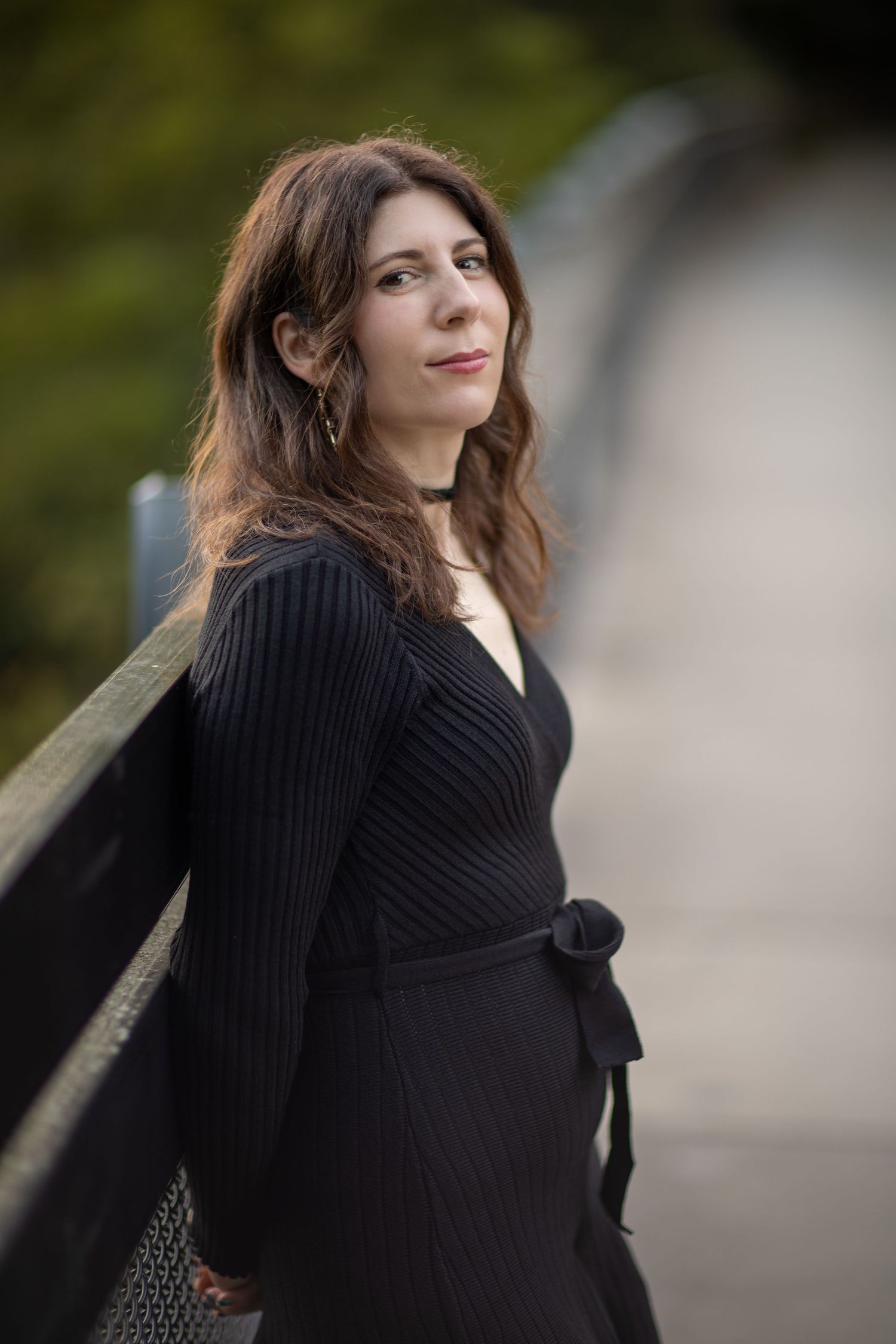 A series of portrait shots showing a person in a black sweater against a blurred outdoor setting.