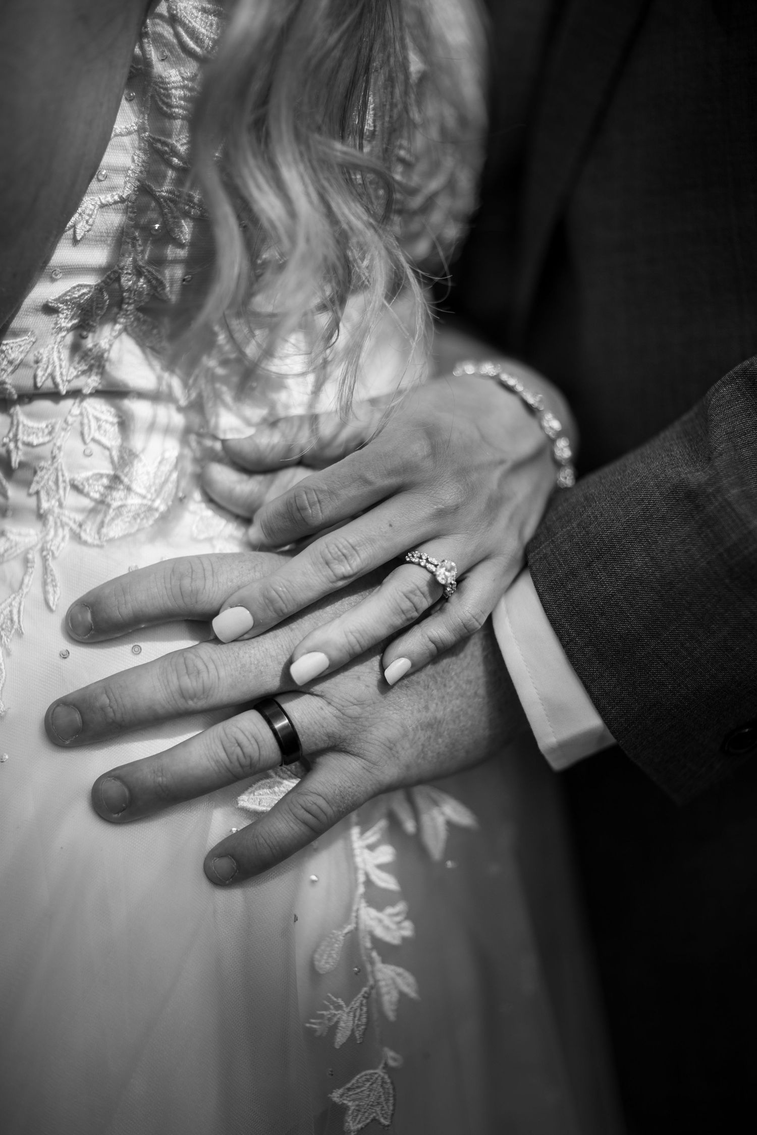 Three black and white detail shots show close-ups of wedding rings being exchanged during a ceremony.