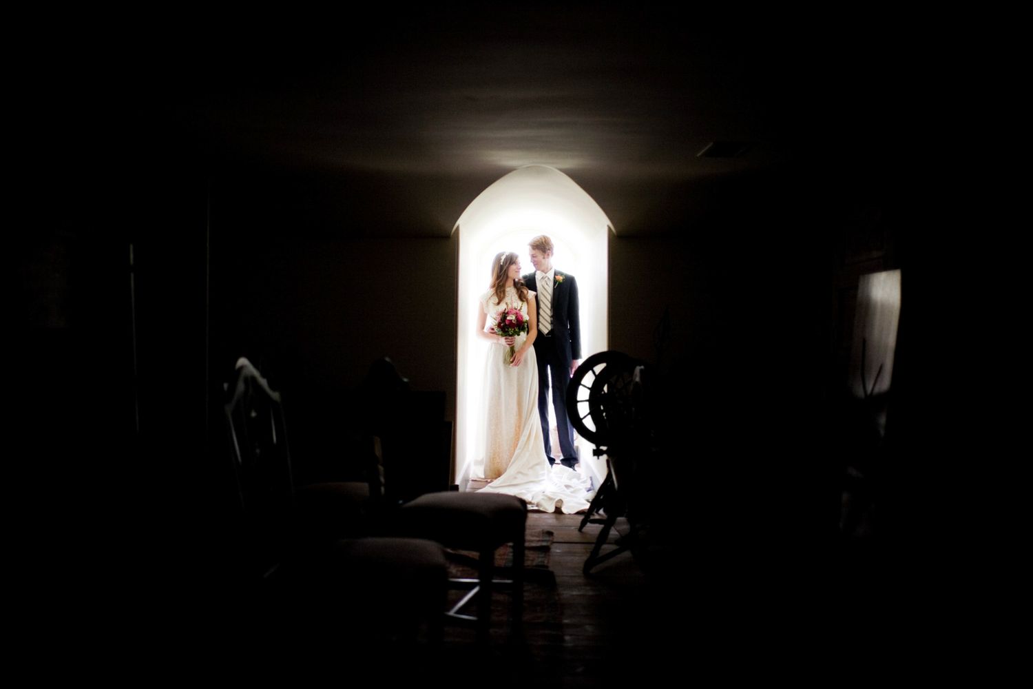 couple kissing in a window of a dark room