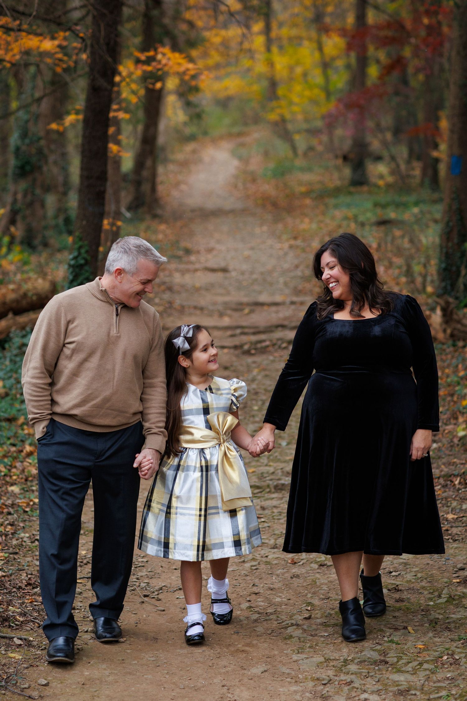 A sequence of candid moments on a leaf-covered forest path during fall, with warm autumn colors in the background.
