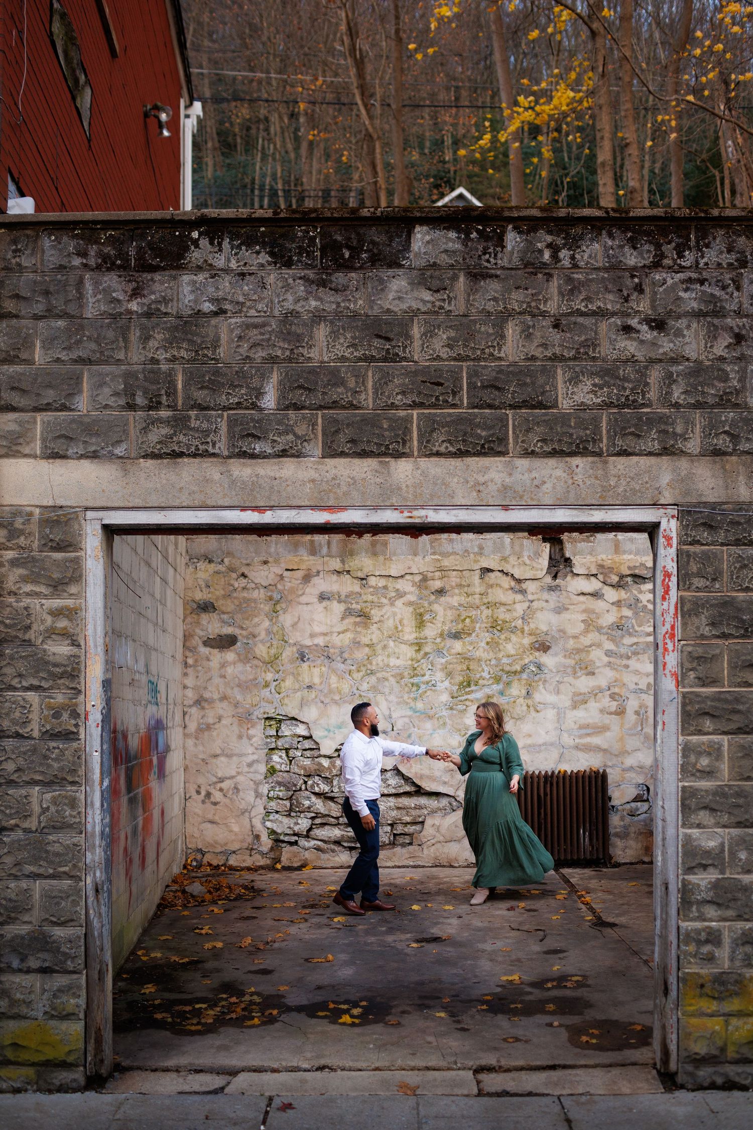 A romantic couple poses for engagement photos against a rustic stone wall in a series of sequential frames.