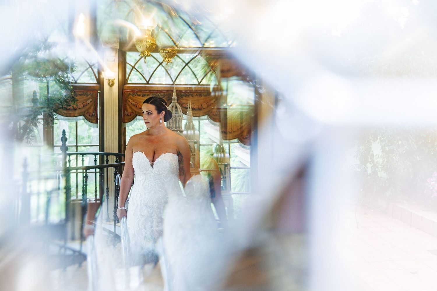 A blurry, ethereal wedding scene with soft white and pastel colors creating a dreamy atmosphere.