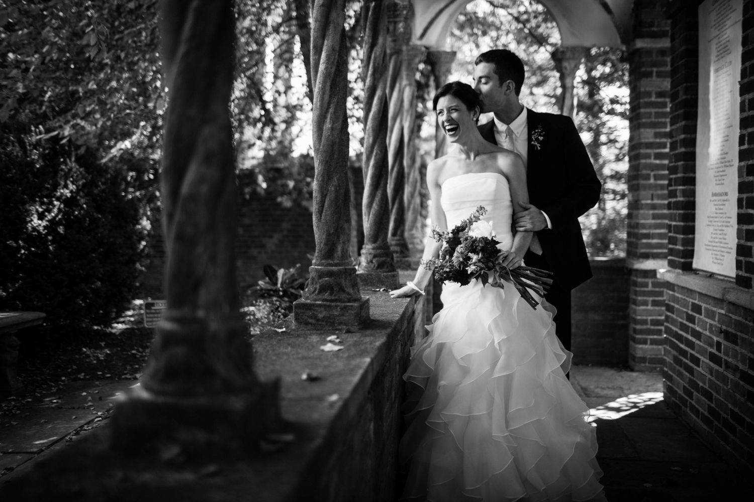 black and white photo of bride and groom and mansion