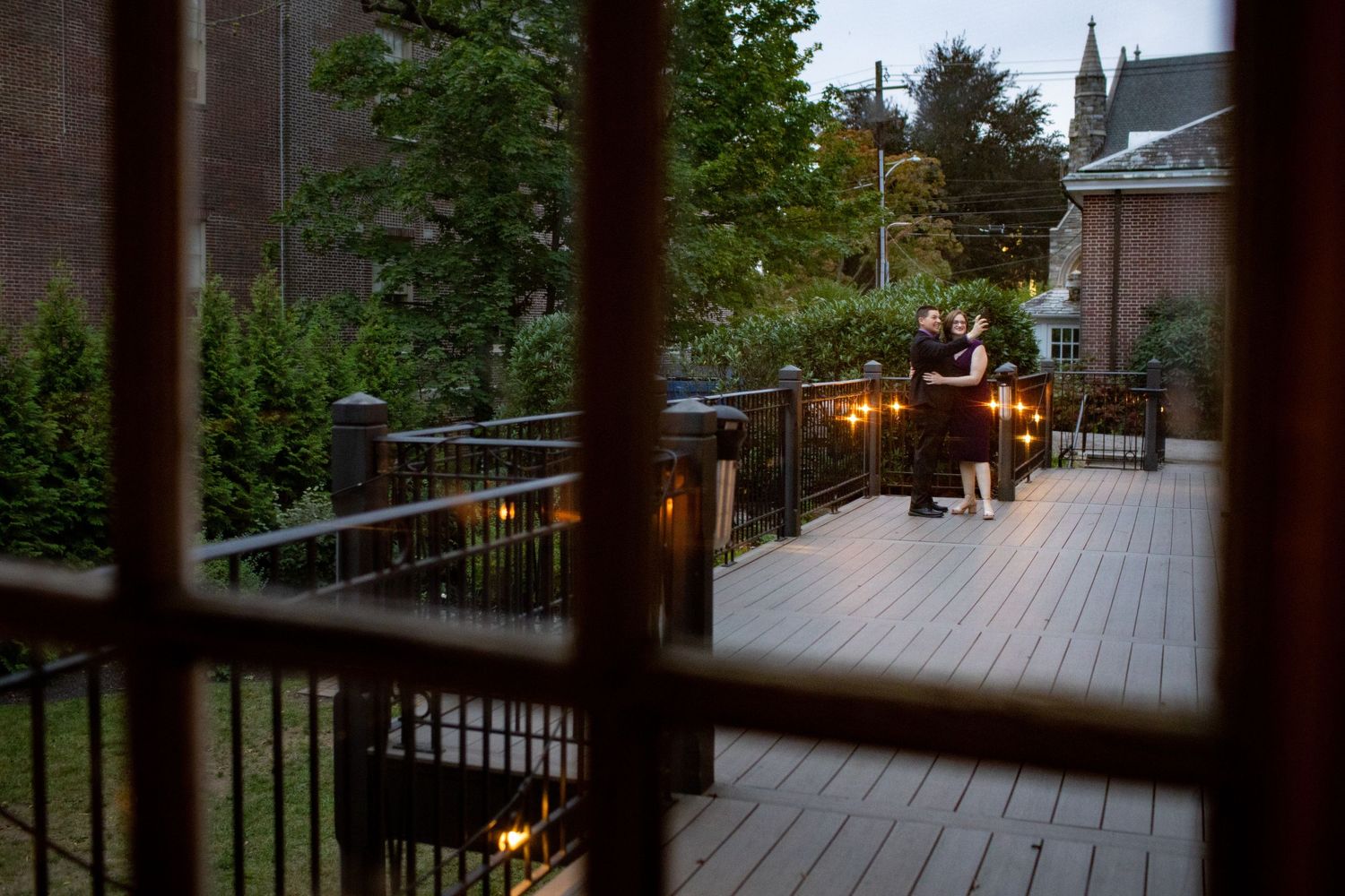 Evening view of an outdoor deck with glowing lanterns and string lights creating a warm ambiance.
