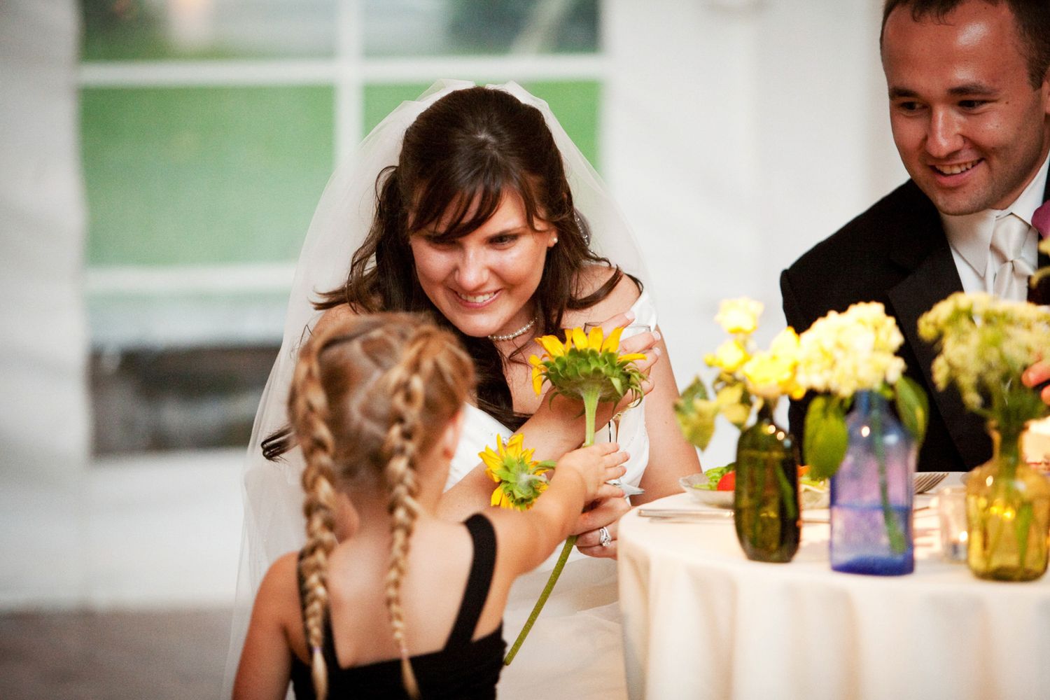 little girl bringing talking to the bride