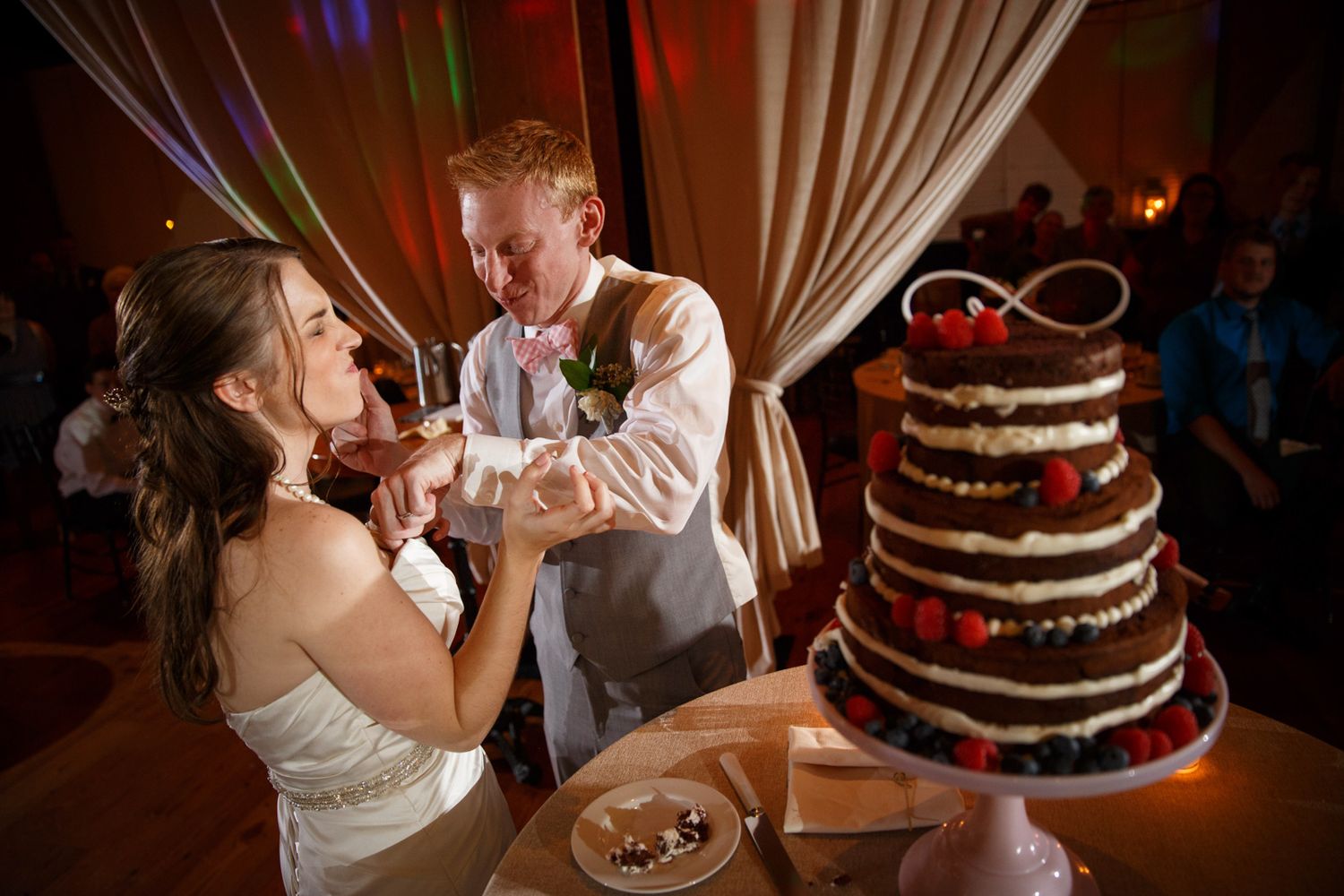 a wedding couple feeding each other cake