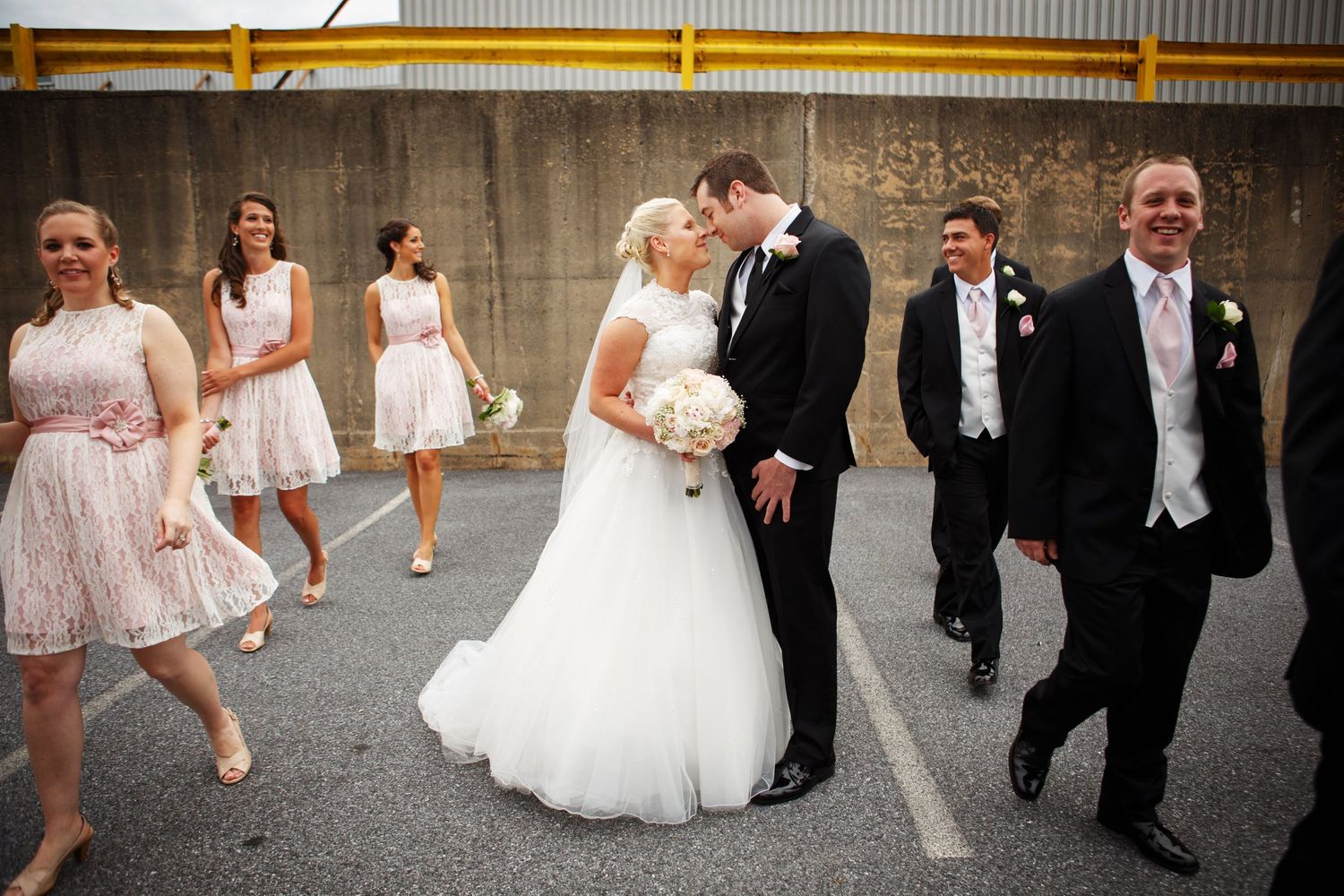 Wedding party walking and celebrating in an urban setting.