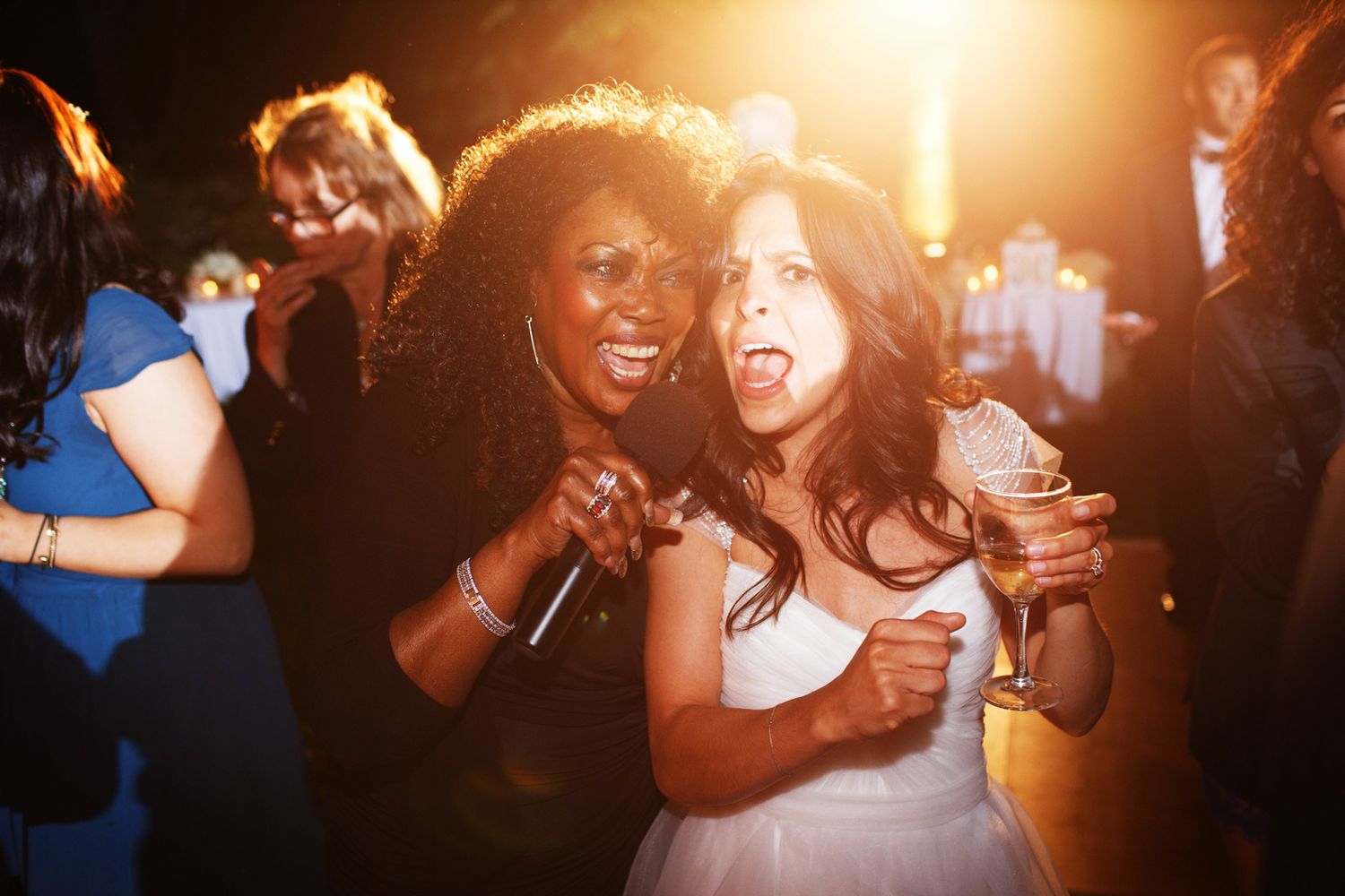 a bride and a singer are both singing into a microphone
