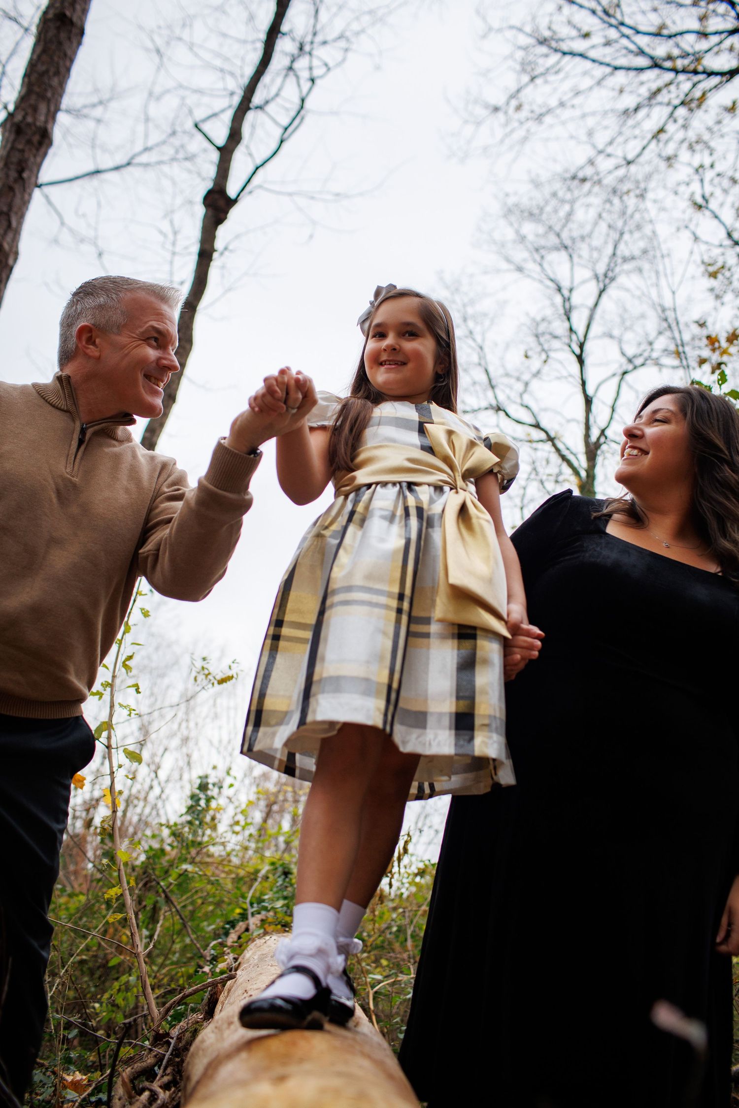 A playful sequence of someone twirling in a plaid dress against autumn trees.