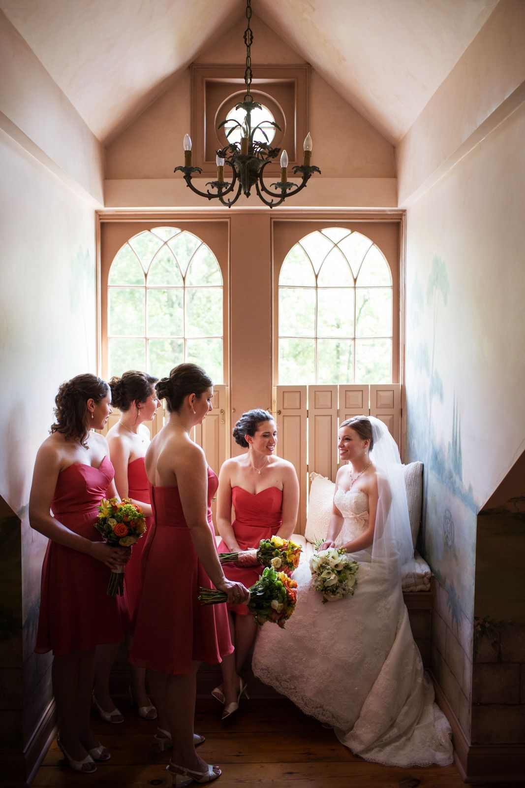 bride and her attendants by a window