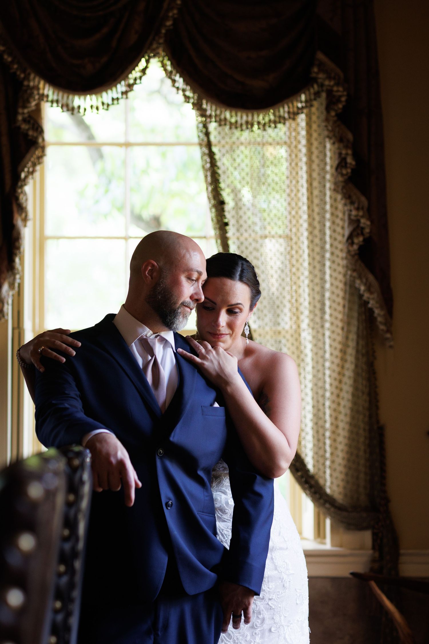 A romantic first dance sequence showing tender moments between newlyweds in an elegantly decorated room with windows.