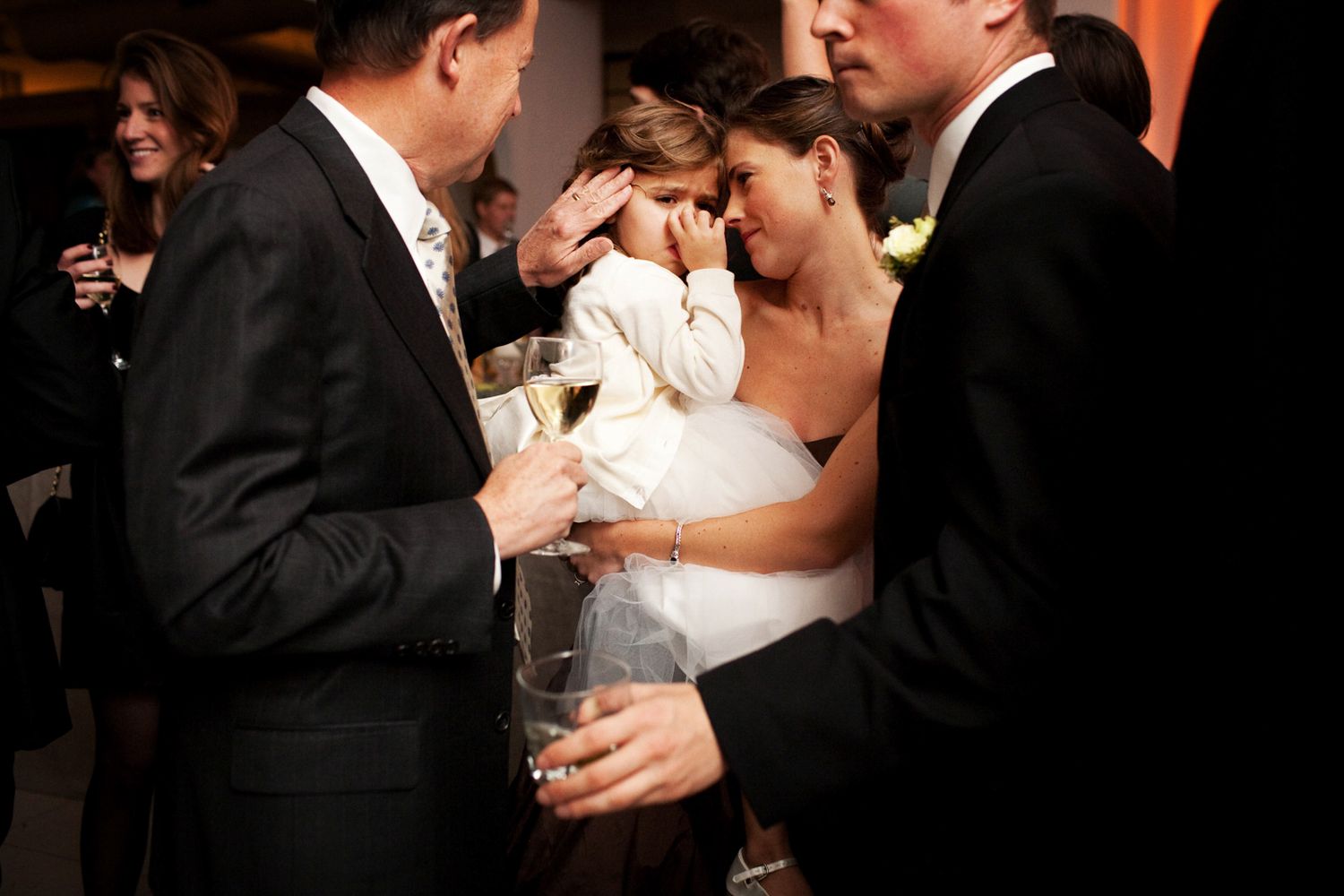flower girl crying and mom consoling her at a wedding