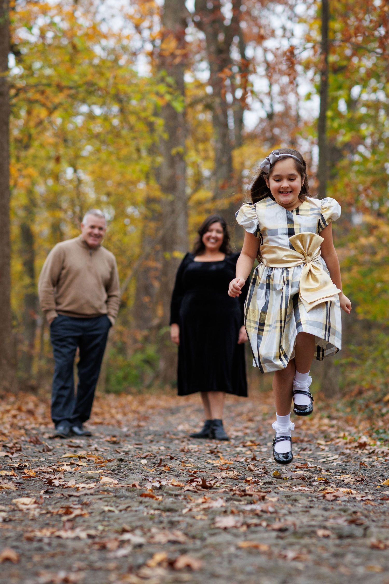 A series of low-angle shots showing someone skipping through fallen leaves in the woods.