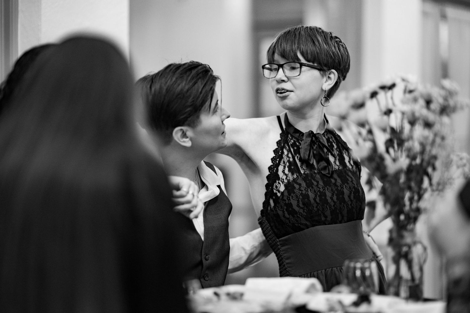 Candid moments of guests laughing and socializing at a formal dinner party.