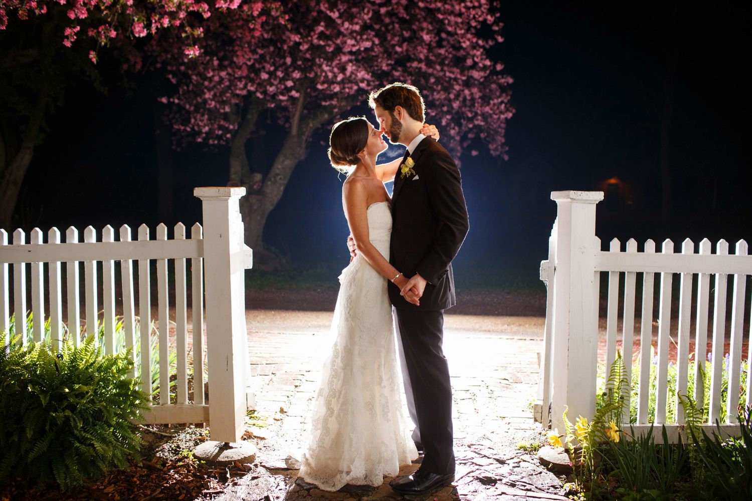 backlit couple ad Landis Valley Farm kissing at the end of their wedding