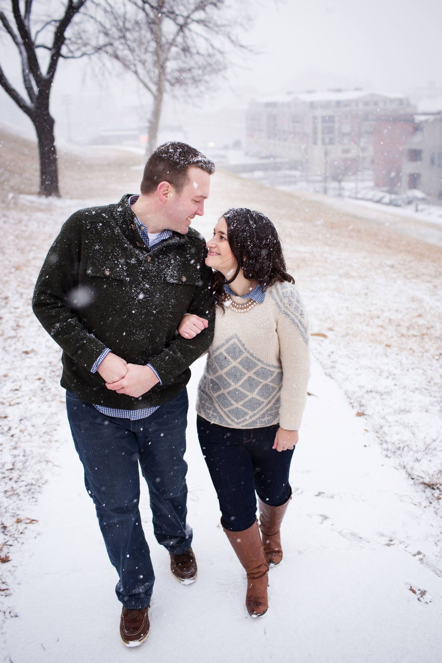 A romantic winter walk through falling snow on a peaceful hillside path.
