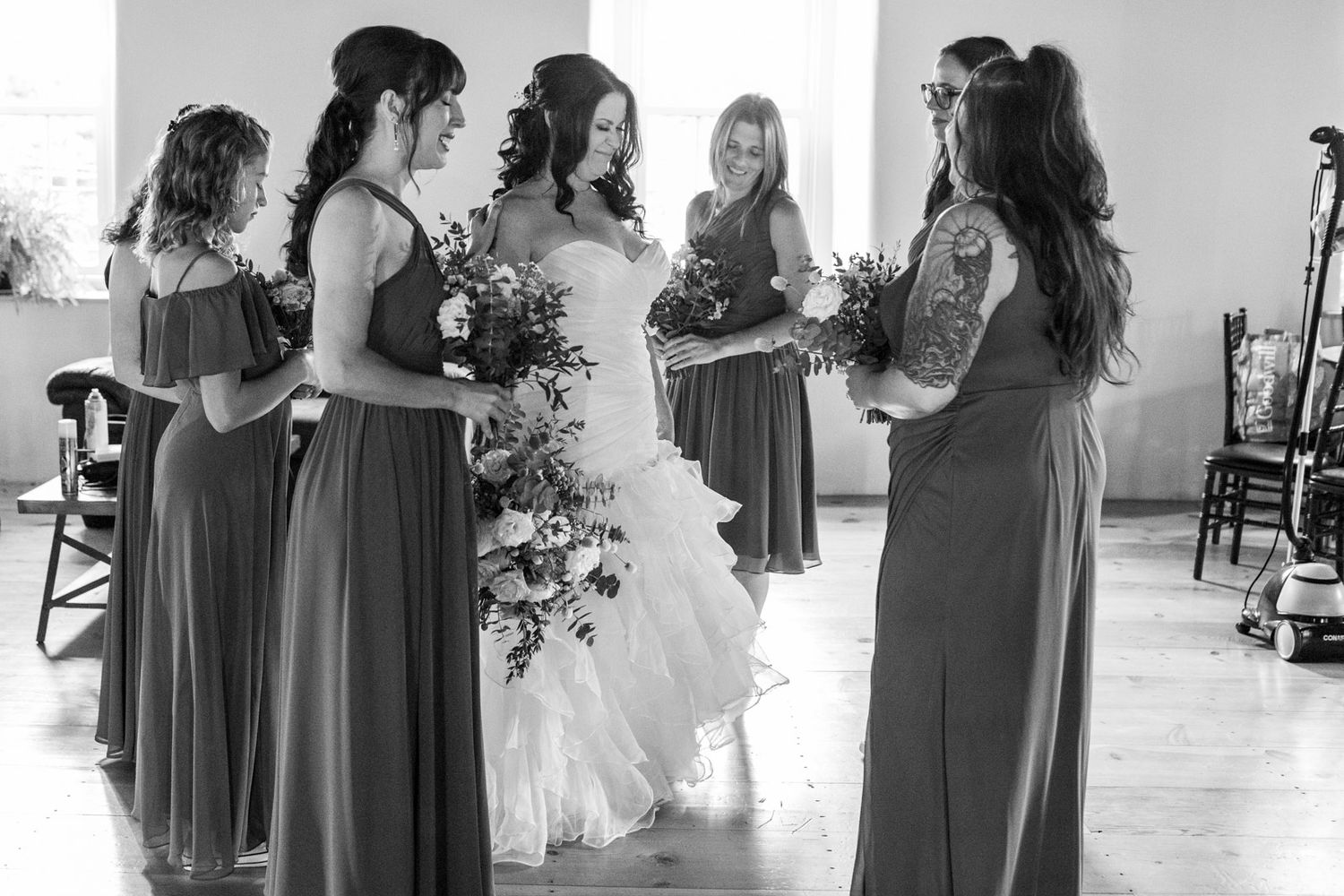 a bride and her bridesmaids pray before a wedding, this is a documentary, photojournalistic moment captured in a real situation
