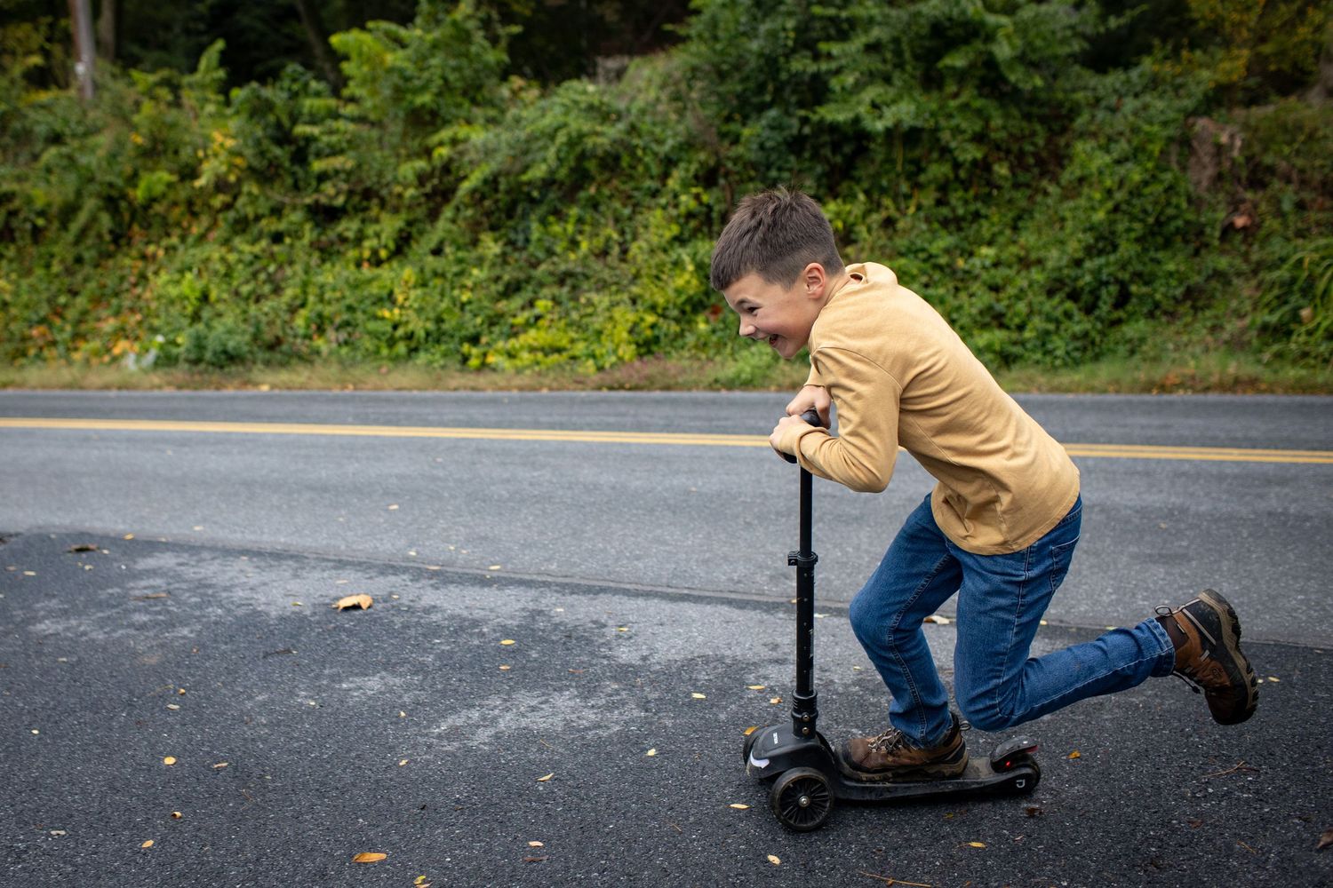 A series of action shots showing someone riding a scooter on a paved road surrounded by green foliage.