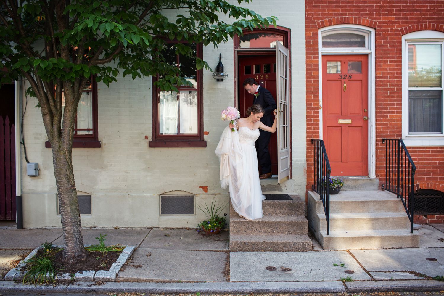 The bride leaving her house in a documentary style photograph. She is on her way to the wedding