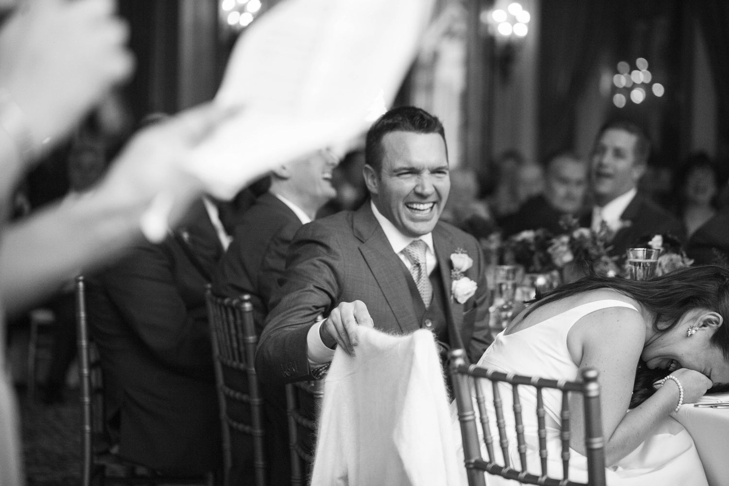 couple laughing at their wedding during a speech