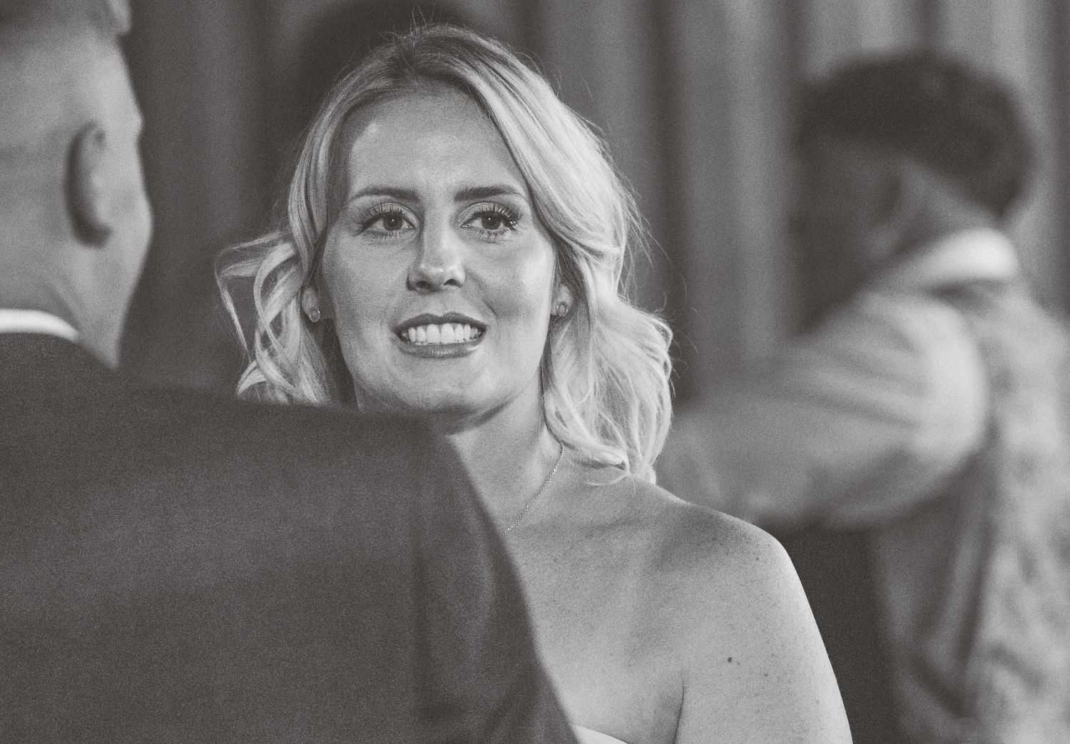 Black and white photos capturing joyful moments at a formal gathering with elegant attire.
